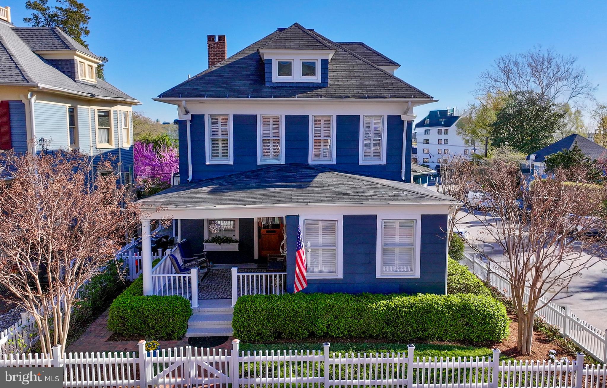 LOCATION, LOCATION!  OPEN HOUSE MOVED TO SUNDAY APRIL 12TH FROM 12-2 PM. 
Welcome to one of downtown Annapolis’ most exceptional offerings. Perfectly positioned in the heart of the Historic District, 98 Duke of Gloucester Street is the kind of property Buyers wait years to find. Set on one of the widest, two-way streets downtown, this rare residence offers the convenience of being just steps from the waterfront, restaurants, shops, and the charm that makes Annapolis so special—while maintaining a sense of privacy rarely found in the city.
Parking is truly unmatched, with four dedicated spaces including two garages (with EV charger), a private driveway, and a parking pad—an extraordinary amenity in the Historic District.
This American Four Square home features 4/5 spacious bedrooms and three full baths, with beautifully designed living and dining spaces that flow seamlessly for both everyday living and effortless entertaining. Elevated above street level, the property enjoys enhanced privacy and light. The main level includes a parlor with a gas fireplace that you could convert to a bedroom and full bath, offering flexibility for guests, office space, or multigenerational living.
Thoughtful upgrades blend modern comfort with timeless character. Recent improvements include a newer kitchen island, a porch enclosure with mini-split HVAC (2019), and a floating deck with a new roof off the primary bedroom (2023)—creating inviting outdoor spaces for relaxing and entertaining. Practical enhancements provide peace of mind, including two new HVAC systems (2025) and a hot water heater with recirculating pump (2026). Bump outs in the family room, dining room and primary bedroom enhance the living spaces.
Craftsman-inspired fir siding, a fully fenced private yard with amazing landscaping, and multiple outdoor living spaces complete this rare downtown offering.
A property that combines historic Annapolis charm, modern updates, exceptional parking, and walkable convenience—this is downtown living at its very best!