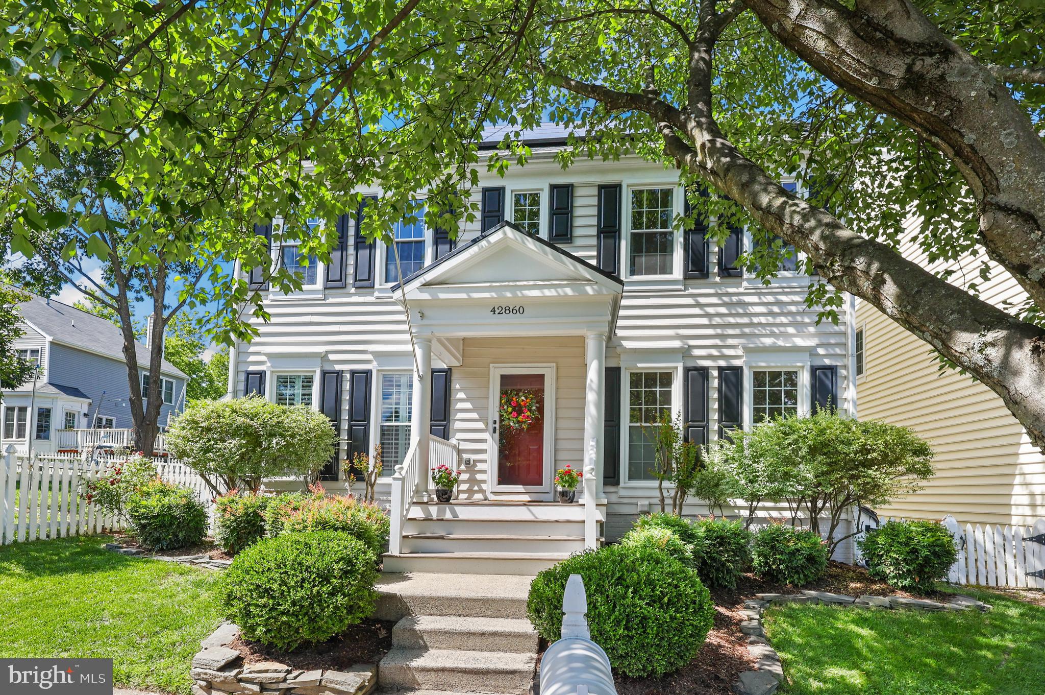 One year home warranty included! Welcome to 42860 Nashua Street — a beautifully updated 3-bedroom, 3.5-bath colonial in the heart of desirable Belmont Greene, Ashburn. Set on a quiet, tree-lined street with exceptional curb appeal, this home blends timeless charm with modern efficiency and one of the largest fully fenced lots in the community. Step onto the welcoming front porch with its crisp white railings and classic picket fence, framed by mature landscaping. Inside, hardwood floors flow throughout the main level into an open, light-filled layout. The updated kitchen is a standout, featuring maple cabinets, granite countertops, stainless steel appliances, a generous center island, and a sunny eat-in area — perfect for casual meals and entertaining. Just steps away, the family room and formal dining space are anchored by a cozy gas fireplace and enhanced with elegant crown molding. Upstairs, the primary suite offers fully renovated luxurious spa-like bath with a soaking tub and glass separate shower. Two additional bedrooms and a full bath complete the upper level. The fully finished lower level provides versatile living space with a large recreation room, a flexible den (ideal as a 4th bedroom or home office), and a full bath — ideal for guests, hobbies, or movie nights. Significant energy-efficient upgrades make this home exceptionally affordable to run: 8kW solar panels (installed  2021) that dramatically reduce electric bills by 50% (4 year average). Additional attic insulation, duct sealing, and wall sealing. New windows throughout. New roof (2017), tankless hot water heater, and energy-efficient front/back doors with storm doors. Aprilaire whole-house humidifier with expanded filtration, and Whole-home network cabling to all rooms/TVs. Outside, the private backyard is a true highlight — one of the largest in Belmont Greene. Enjoy the spacious rear deck with fire pit, room for barbecues and gatherings, and a dedicated playground area. A rear-entry 2-car detached garage plus extra off-street parking complete the picture. Belmont Greene offers the perfect balance of community and convenience. Residents enjoy pools, tennis courts, playgrounds, parks, trails (including easy access to the W&OD Trail), snow removal, and trash service — all covered by a low HOA fee. The neighborhood has that warm, lived-in “Main Street” feel with friendly neighbors and tree-lined streets. Top-rated Loudoun County schools (Belmont Station Elementary, Trailside Middle, Stone Bridge High), shopping at One Loudoun, and quick access to Route 7, the Greenway, Silver Line Metro, and Dulles Airport put everything you need just minutes away. This is more than a house — it’s a thoughtfully maintained, energy-efficient home that feels genuinely loved and move-in ready. Whether you’re a first-time buyer, growing family, or looking to downsize, this home delivers charm, comfort, practicality, and outstanding value in one of Ashburn’s most beloved communities. Schedule your private showing today and make this gem yours!