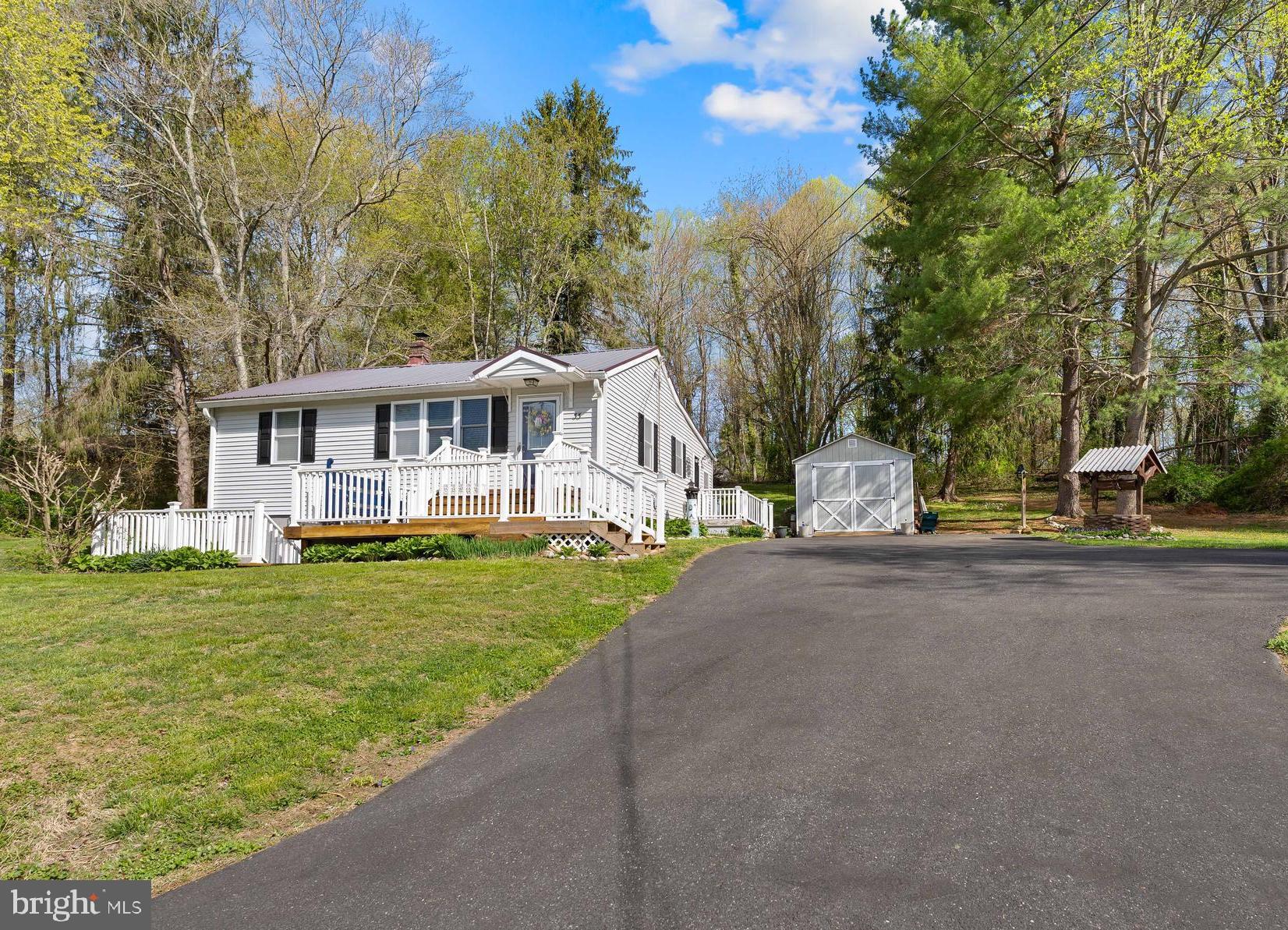 This quaint and well maintained 2-bedroom, 1-bath ranch offers the ease of one-level living in a bright and inviting setting. Natural light fills the home, highlighting the beautiful hardwood floors that run through the living room and both bedrooms. The family room provides a comfortable space for everyday living and entertaining, with room for a dining table. Double sliding doors lead to a back deck, creating an easy flow for indoor-outdoor living. Renovated in 2014 by the previous owner, the home features updated windows, siding, kitchen, bathroom, and a durable metal roof. Additional improvements have been completed within the past three years, including the well pump, sump pump, hot water heater, and pressure tank. A walk-up attic, partially floored, offers convenient additional storage space.  Adding even more versatility is a 12 x 30 shed with electricity—ideal for a workshop, storage, or even accommodating a vehicle. A perfect blend of charm, updates, and functionality, this home is ready for its next owner to move right in and enjoy.