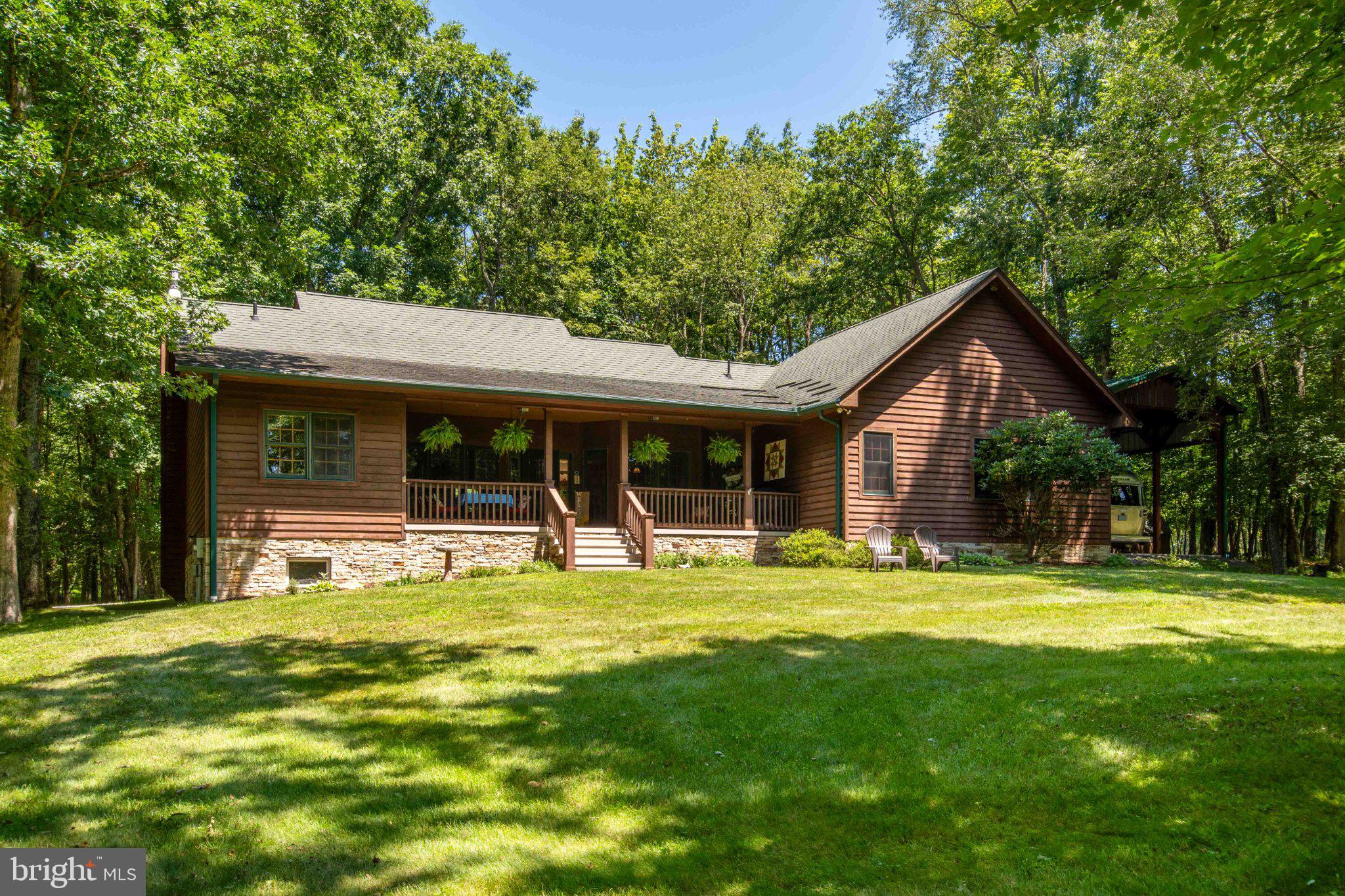Fall in love with the perfect blend of comfort, privacy, and outdoor adventure in this beautifully maintained home nestled on 3.67 wooded acres overlooking scenic Meadow Lake. Thoughtfully designed for easy living, this 3-bedroom, 2.5-bath home features an open floor plan where the spacious great room flows seamlessly into a beautifully updated kitchen complete with granite countertops, making it the perfect space for gathering with family and friends. Peaceful lake views can be seen throughout the home. The spacious primary suite features a walk-in closet and a private bath with double vanities and a custom walk-in tile shower. Main-level laundry and an attached two-car garage add everyday convenience, while central air, a propane furnace, and a cozy wood-burning fireplace insert provide year-round comfort. The expansive unfinished basement offers endless possibilities for additional living space, a recreation room, workshop, or home gym. Step outside to enjoy the tranquility of nature from the front and back covered porches. The community offers a beautiful private lake perfect for kayaking, fishing, swimming, relaxing by the beach and 3 community docks. Additional amenities include private walking trails, and a storage shed that provides even more space for tools and outdoor equipment and the impressive 32' x 12' RV pavilion complete with 50 AMP, water and sewer hookups.  Located in the desirable Meadow Lake Estates community, you'll enjoy a peaceful rural setting just minutes from Herrington Manor and Swallow Falls State Parks. As an added bonus, the community borders 598 acres of Maryland DNR land fronting the Youghiogheny River, offering endless opportunities for hiking, wildlife watching, and outdoor recreation. Whether you're searching for a full-time residence, a mountain retreat, or the perfect place to embrace the beauty of Western Maryland, this exceptional property is ready to welcome you home.