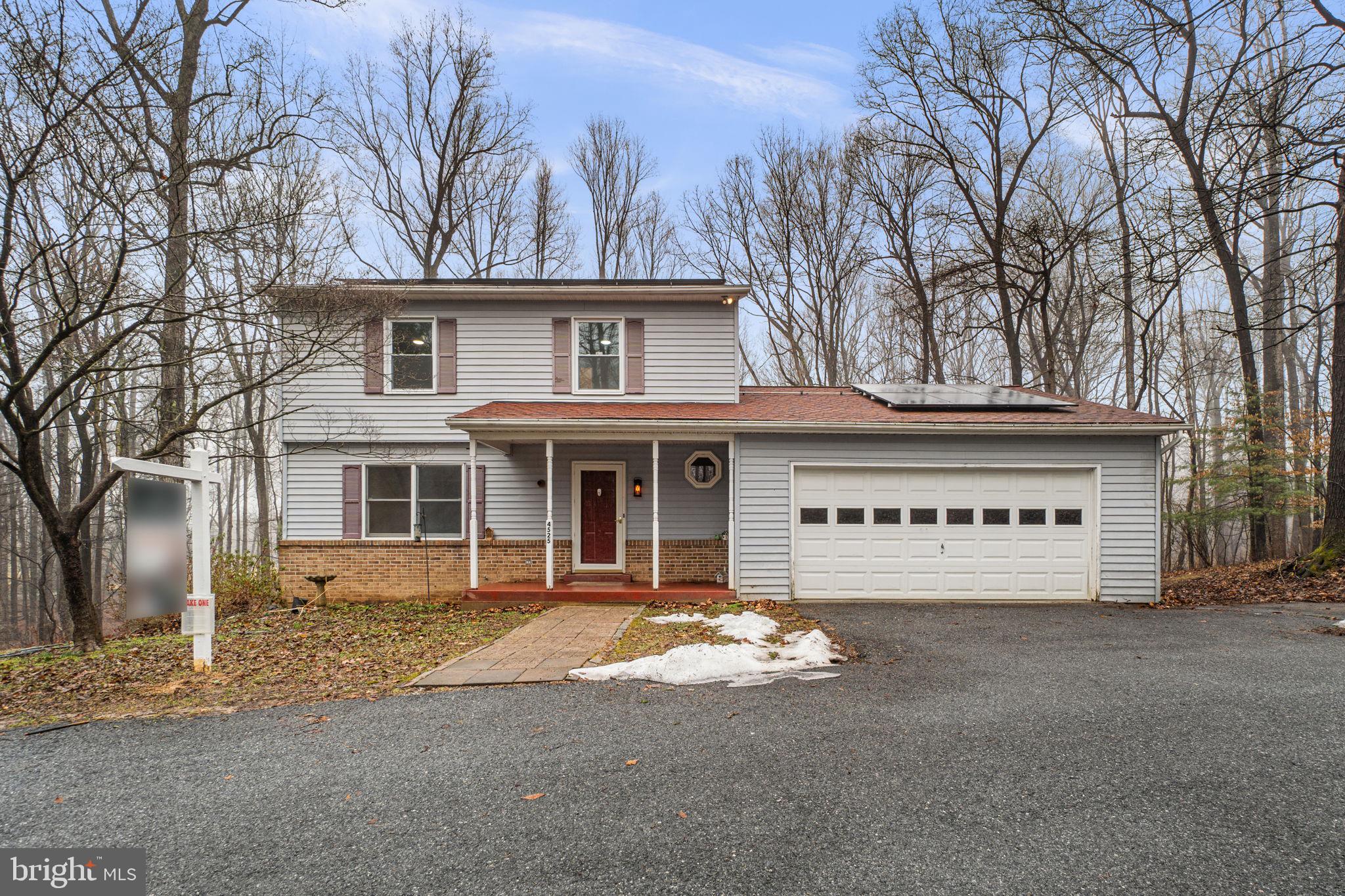 Back on the Market!! Thoughtfully priced with its condition and distinctive setting in mind, offering great potential for customization.Charming Colonial residence offering 4 bedrooms, 3.5 bathrooms, 2,365 finished square feet, and a 2-car garage, nestled on over two and a half tranquil acres in desirable Covers Corner. An asphalt driveway leads to the welcoming front porch, setting the tone for the home’s classic appeal. Inside, a traditional floor plan unfolds with luxury vinyl plank flooring throughout the main level. The foyer opens to a spacious living room that flows seamlessly into the formal dining room, creating a comfortable layout for everyday living and entertaining. The charming eat-in kitchen features stainless steel appliances, including a refrigerator installed in 2022, vibrant mosaic tile backsplash, stylish cabinetry, a pantry, ample counter space, and a cozy breakfast area with sliding door access to the exterior. Open to the kitchen is the inviting family room, highlighted by plush carpeting and a wood stove framed by a striking floor-to-ceiling brick surround. A conveniently located powder room completes the main level. Upstairs, the primary suite offers a comfortable retreat with carpeting and a private attached bathroom featuring beautiful tilework and a glass-enclosed shower. Three additional bedrooms and a second full bathroom complete the upper level. The walk-out lower level expands the living space with luxury vinyl plank flooring throughout the recreation areas, a third full bathroom, a versatile bonus room with a walk-in closet ideal for guests or a flexible living space, and a laundry room (washer and dryer 2024). Additional updates include HVAC (2025). Outdoor highlights include solar panels added in 2024, a large deck overlooking the peaceful wooded lot, complete with a charming footbridge crossing a scenic creek—creating a private, nature-filled setting. Ideally located in Covers Corner, the property offers a sought-after setting with convenient commuting access to Baltimore, Frederick, and Washington, D.C. *Select photos include virtual staging for illustrative purposes only.