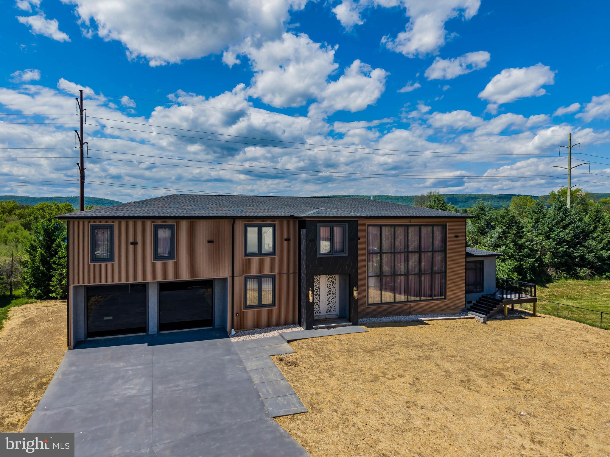 Brand‑new contemporary home featuring soaring high ceilings, sleek glass railings, and designer chandeliers throughout. Enjoy an open layout with tile flooring across the entire home, custom built‑in cabinets with integrated lighting, and oversized windows that fill every room with natural light. The property includes an oversized garage, a beautiful sunroom, and a fully finished basement offering additional living space. Washer refrigerator dryer are included for added convenience. Modern design, premium finishes, and exceptional craftsmanship make this home truly one of a kind.