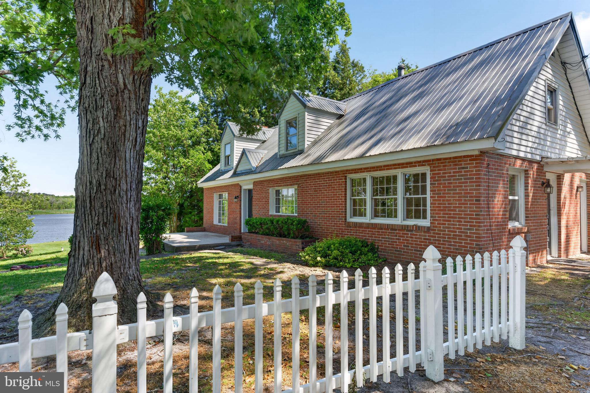 Welcome home to 28266 Riverside Drive, a rare offering nestled on the Wicomico River. It's not every day you find a spacious waterfront home with breathtaking views of the river AND a fully separate guest cottage/accessory dwelling unit! The possibilities await, and the only thing missing is your imagination and touch to make this home exactly what you need it to be!

Featuring 4 spacious bedrooms, 2 full bathrooms, and a timeless charm; this sturdy brick built cape cod(main house) greets you with a large concrete patio overlooking the river, before entering over 2000sqft of living space accented with knotty pine, exposed beams, brickwork, and hardwood floors. Both living structures are constructed on concrete slab, eliminating the possibilities of a problematic crawlspace! While these add to the eclectic eastern shore charm, thoughtful upgrades over recent years like long-lasting metal roofing, new heating pump, vinyl replacement windows, and a lead-free certification offer the peace of mind to help you focus on making the personal touches that will make this house HOME! 

The main house features a large bedroom on the entry level with it's own separate exterior entry, and a full bathroom on the entry level, while upstairs features 3 spacious bedrooms and a flex space in the hallway that could serve as a sitting/reading room, and an additional full bathroom to accompany the bedrooms upstairs. The living room features large bay windows, offering expansive views of the river right from the comfort indoors! 

The guest cottage features just over 400sqft of finished living space, complete with fully functioning kitchen, bedroom with full ensuite bathroom, and laundry. A covered patio adorns the front of the cottage, offering shade and outdoor flex space, helping you make the most of this hidden gem! 

Boasting ample space inside and out, this home looks across the river towards the historic Pemberton Park, offering peace of mind knowing that your waterfront views will always look as picturesque as now. This property also boasts approximately 25 feet of Wicomico River shoreline, recent survey available upon request. 

Located in the Fruitland Primary school district, this home is minutes from Fruitland and Downtown Salisbury, with shopping, restaurants, schools, healthcare, and recreation aplenty. Located under an hours drive to Maryland, Delaware, and Chincoteague Island VA Beaches, and just under 3 hours from major DC, Baltimore, and Philadelphia Metropolitan areas, don't miss this rare opportunity to create your own private waterfront paradise! Call to schedule a private tour today!