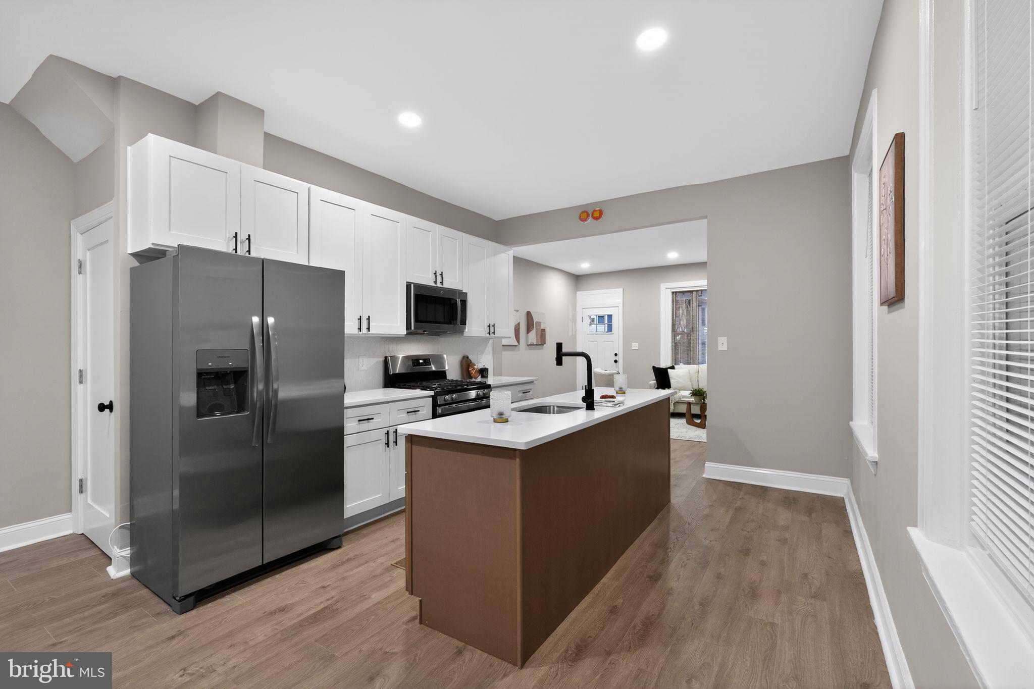 Welcome to this beautifully renovated 4-bedroom, 2.5-bathroom home located in the heart of Philadelphia. The main level has been completely redone and features brand-new laminate wood flooring throughout the living room, dining room, and kitchen, creating a seamless and modern flow. The stunning kitchen has been fully renovated with white shaker cabinets, granite countertops, chic black hardware, and stainless steel appliances. A stylish center island with wood-toned shaker cabinetry, white granite countertops, and a built-in dishwasher adds both functionality and visual appeal. A newly renovated half bathroom completes the main level.
The second floor offers three spacious bedrooms, all finished with brand-new wall-to-wall plush carpeting, along with a newly renovated full bathroom. The third level is dedicated to the expansive primary suite, featuring brand-new plush carpeting and a truly impressive en-suite bathroom. This oversized bathroom includes new ceramic tile flooring, a soaking tub, a separate glass-enclosed shower, a high-end vanity, and a new commode, offering a spa-like retreat. Additional highlights include brand-new central air conditioning, making this home completely move-in ready.