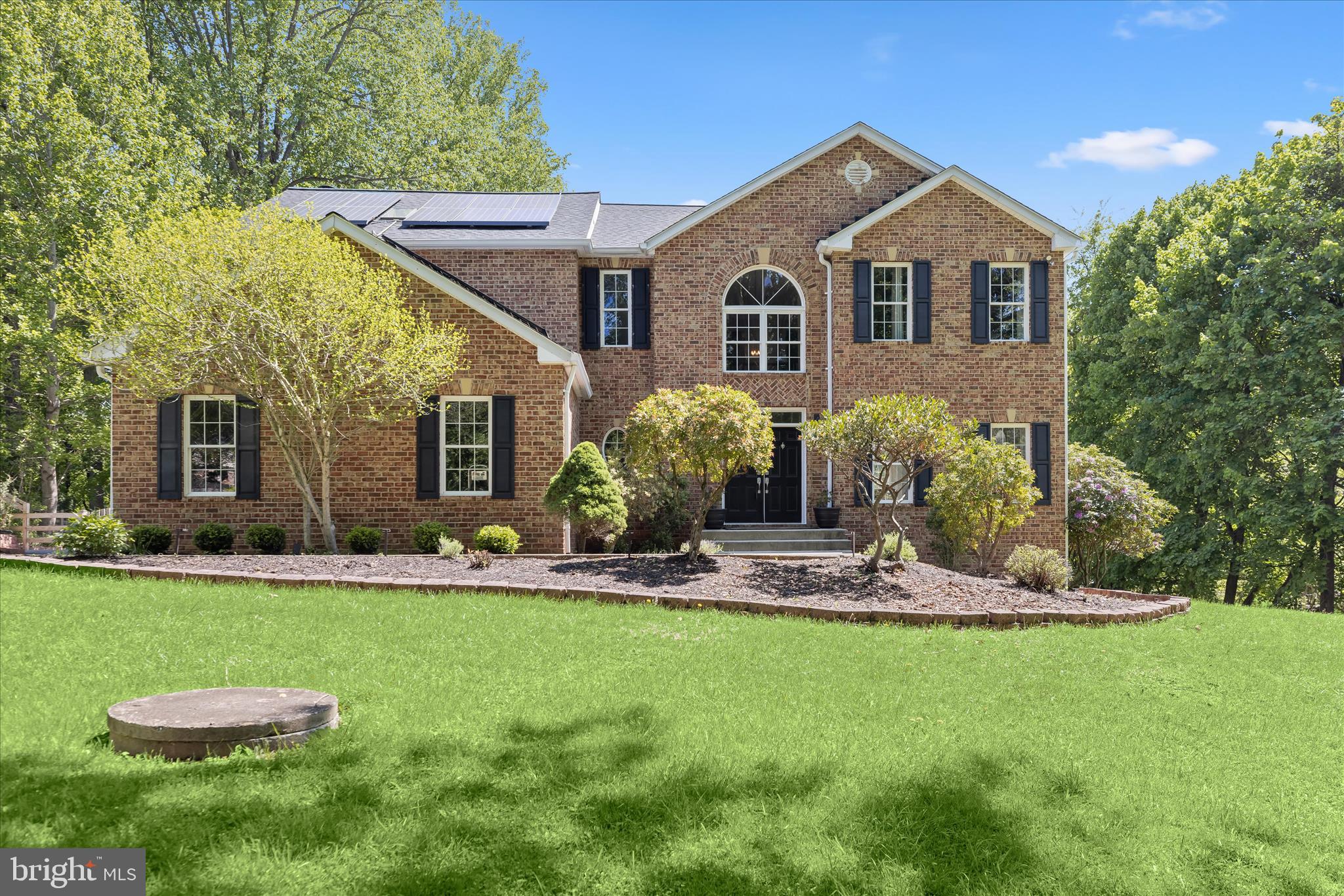 Introducing this exceptional four bedroom, three and a half bathroom home tucked away at the end of a long private driveway on a 1.53-acre lot surrounded by trees in Greenspring Valley. This peaceful oasis offers three finished levels of light-filled living space. Double doors welcome you into a two-story foyer featuring luxury vinyl plank flooring, a neutral color theme, and elegant crown molding that continues throughout the main level. The inviting front living room flows seamlessly into the dining room, creating ideal spaces for both entertaining and everyday living. The kitchen is equipped with stainless steel appliances, granite countertops, an island, and a pantry. Just beyond, the breakfast nook showcases a vaulted ceiling with new skylights and sliding glass doors leading to the deck. A cozy family room with a wood-burning fireplace provides the perfect place to unwind. A half bathroom and laundry room with access to the two-car garage and a large walk-in storage closet complete the main level. Upstairs, the primary suite serves as a luxurious retreat with two walk-in closets and a private balcony. The en-suite bathroom features a walk-in shower with dual shower heads, a soaking tub, skylight, and dual sink vanity. Three additional bedrooms and a shared hall bathroom complete the upper level. The finished walk-out lower level offers a massive recreation room with a full second kitchen, ideal for entertaining or a guest suite. A third full bathroom includes a walk-in shower, while a versatile den behind glass doors is well suited for an office, movie room, gym, or potential bedroom. Utility and storage rooms are also located on this level. Enjoy the scenic surroundings from the deck overlooking the backyard and wooded setting, or relax on the rear patio below, all enclosed by an 8-foot fence. Recent updates include a new roof and breakfast room skylights in 2025; water heater, well pump, and furnace in 2024; and a washer, dryer, half bathroom update, and luxury vinyl plank flooring in 2023. Additional highlights include zoned heating and cooling and leased solar panels.