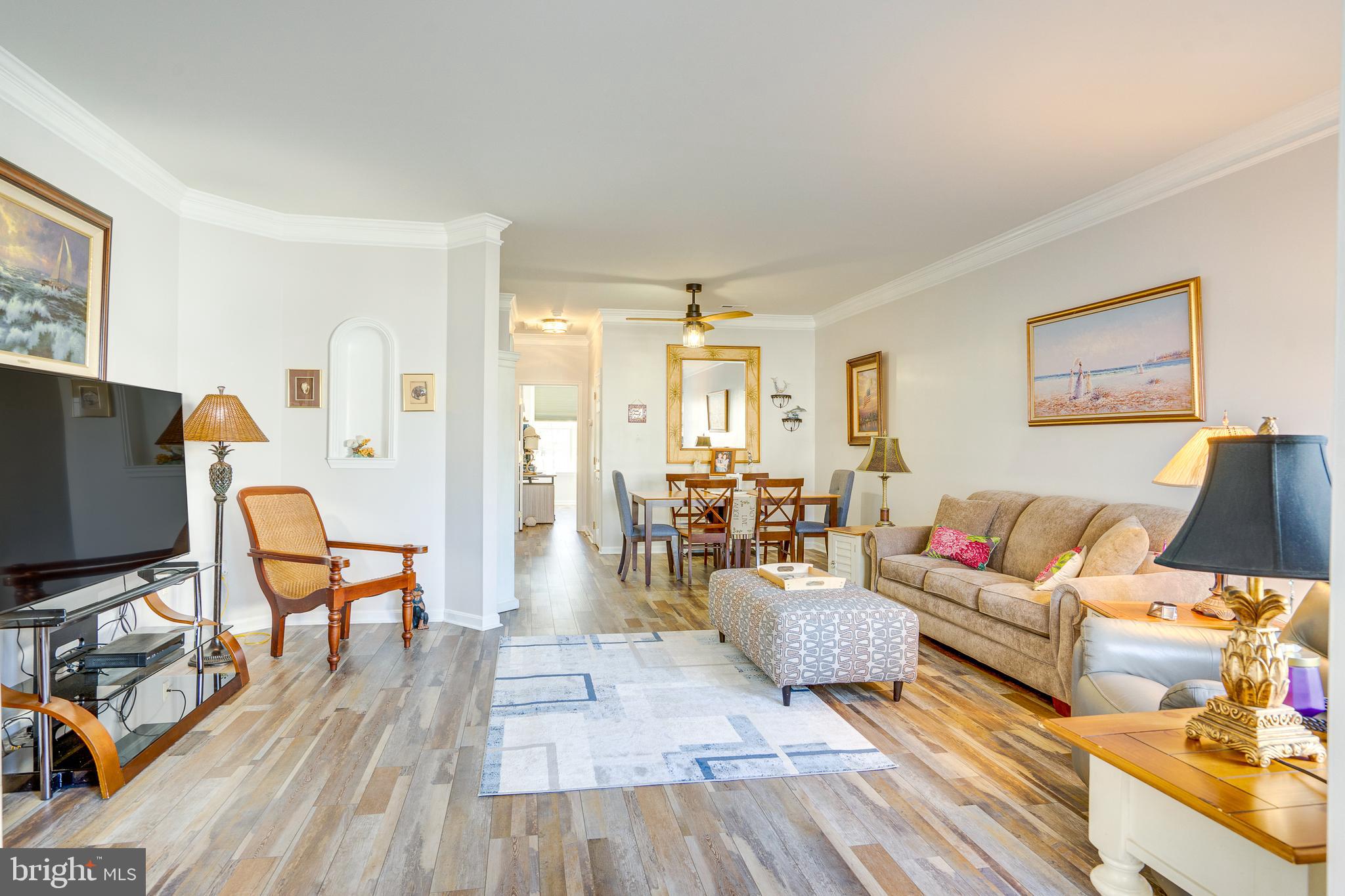 Beautifully Updated One-Level, Interior Row/Townhome This one won't last long in the award-winning Heritage Hunt Neighborhood, a 55+ community in Gainesville, Virginia. Residents enjoy living in a prime location in the heart of Prince William County, 30 miles west of Washington D.C. This upscale, gated community combines the area's rich history with luxurious, country club living. Here, residents can get to know their neighbors, stay in shape, become active within the community, and pursue their own personal hobbies and special interests. 
Key Features:
This 2 Bedroom/2 Bath beauty with a 1-car garage is the definition of modern style! Meticulously maintained and updated (2023), this home has it ALL! ✨ Stylish wide plank LVP flooring throughout. Professionally painted trim from top to bottom, all new ceiling fans, light fixtures, black-out shades, landscaping & shrubs, slate stone patio in  back with new, gated fence (2023/new survey conducted).  Nine Foot ceilings in the living area with crown molding throughout living room and dining room with front windows that bathe the floor in natural light.   Updated kitchen with all new quartz countertops (neutral colors), black, Whirlpool appliances, cabinetry refacing with new pulls, and a gray backsplash paint will lead you into the cozy family room. Primary suite, walk-in closets and a luxurious bath featuring with shower.  The finished 1-car garage boasts an epoxy floor. Prime location within the community; adjacent to golf course – back: lush trees, ample guest parking, and just a brief walk to the community pool, tot lots, and picnic area  Convenience is key – less than a mile to "Park and Ride" bus lot, UVA Haymarket Medical Center, Rt 66, and minutes away from downtown Gainesville shopping, coffee shops, dining, weekly farmers markets, and more!  Roof (2017) HVAC (2010) Water Heater (4/23).  A Capital Contribution Fee of $4,800.00 is assessed and collected at Settlement.  Floor Plan pdf is located in "documents" section of this listing.  Have a survey too if interested.  List of Upgrades since purchase in 2022 located in "documents" section as well.