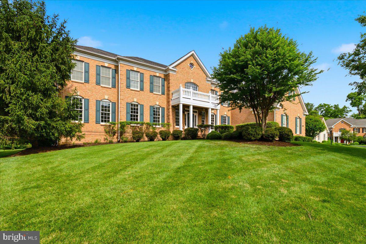 Welcome to 5808 Malvern Hill Court.  This stunning 9,600+ square foot 3 sided brick home offers 4 bedroom suites, 4 full bathrooms, 1 half bathroom, 3 car side-load garage featuring an EV charging station. Situated on a private .69-acre lot backing to tranquil woodlands, the residence was thoughtfully designed by the original owners with no expense spared and no detail overlooked.
From the moment you enter, you are greeted by a dramatic two-story foyer featuring marble floors and a dual staircase. This leads directly into a spectacular two-story family room and a true chef’s kitchen. The gourmet kitchen boasts a four-foot bump-out, granite countertops, elegant premium cabinetry, and top-of-the-line GE Monogram stainless steel appliances—including a 6-burner cooktop with separate griddle, wine chiller, two dishwashers, a built-in refrigerator, built-in microwave, wall oven, and a massive center island.
Throughout the main level, you’ll find luxurious finishes such as hardwood floors and exquisite trim work. The home also includes formal living and dining rooms, a large home office, and an impressive great room addition that adds over 1,200 square feet of living space compared to the base floor plan. Indoor-outdoor living is seamless, with the kitchen opening to a large screened porch and a beautiful stone patio—perfect for entertaining.
Upstairs, each of the four bedroom suites offers privacy and comfort, with two featuring charming sitting areas. The expansive primary suite offers exceptional luxury, complete with a spacious sitting room, tray ceiling, spa-inspired bath with a soaking tub, 2 separate enclosed water closets and 2 oversized walk-in closets.
The lower level provides over 3,000 square feet of untapped potential, ready for you to create your ideal recreation space.
Located in Dominion Valley Country Club—one of Northern Virginia’s most prestigious communities—this home offers an unparalleled country club experience. Residents enjoy a 36-hole Arnold Palmer championship golf course, elegant and casual dining options, a state-of-the-art fitness center, year-round indoor and outdoor pools, newly renovated tennis and pickleball courts, walking trails, tot lots, and much more. Excellent schools are within the community, with shopping, dining, and medical facilities just minutes away.