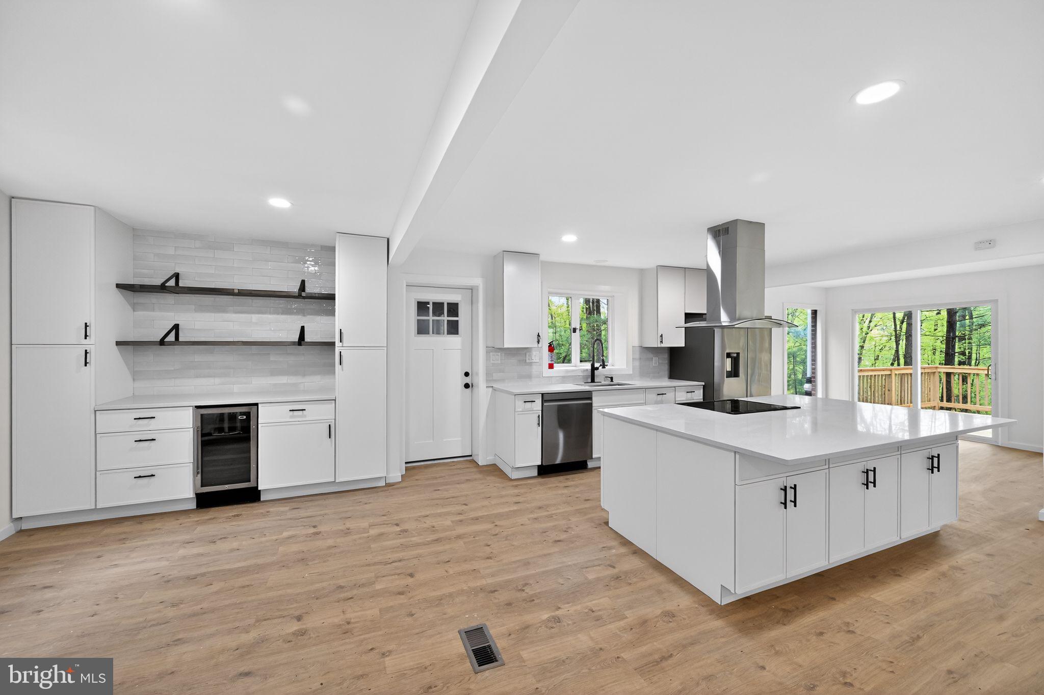 Beautifully remodeled 5-bedroom, 3.5-bath residence in Freeland showcasing an airy open-concept kitchen outfitted with stainless steel appliances and a seamless flow into the living space—perfect for both everyday living and entertaining. The kitchen is a true centerpiece, featuring a huge island with a built-in stove, abundant cabinet storage, additional counter space, and a dedicated wine fridge for added convenience and style.

Step directly from the kitchen onto a walk-out deck, creating an ideal indoor-outdoor connection for dining, relaxing, or hosting guests.

Each bedroom is generously sized, offering oversized layouts that provide comfort, flexibility, and plenty of natural light. The fully finished basement further expands your lifestyle options with versatile space ideal for a home theater, gym, or relaxation area.

Thoughtfully updated throughout and completely move-in ready, this home blends modern upgrades with spacious design to meet all your needs.