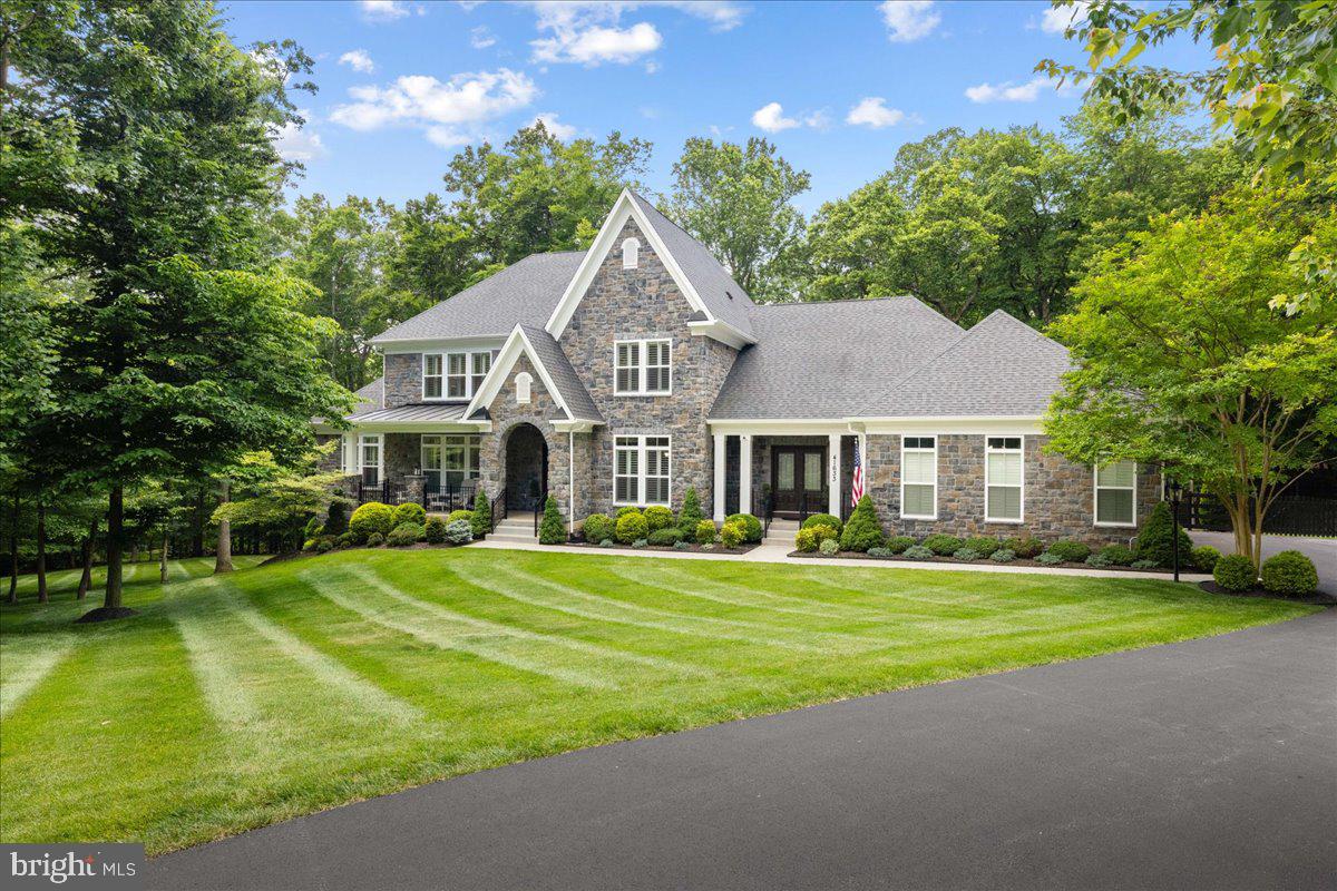 This exceptional 4-bedroom, 3.5-bathroom haven seamlessly marries modern comforts with the tranquil beauty of nature. Nestled at the peak of a picturesque private drive, the cul-de-sac home is within the esteemed Catoctin Springs Conservancy, boasting fewer than 20 homes. The Colonial Stone residence sits gracefully upon 3 acres of lush, wooded landscape. The home boasts a host of distinctive features, including the latest in sustainability with a state-of-the-art 52-panel Enphase Solar and Battery System, complemented by a reliable 20 KW Generac Generator. Moreover, it's fortified with 3M™ Impact Protection window film, ensuring 99% UV ray blockage, along with a Water Well and Septic system, Water Purification System, and a 1000-gallon underground propane tank, promising self-sufficiency, and peace of mind. Crafted with meticulous care, the home showcases 2 x 6 framing and Stone Veneer Masonry, lending timeless elegance to its exterior. Inside, the home offers 4,500 finished square feet of luxurious living space, and a sprawling 3,270 sq. ft walk-out basement presents endless possibilities for customization, tailored to your unique lifestyle. The main level welcomes you with a luxurious primary bedroom, complete with a spacious sitting area and dual walk-in closets. The accompanying primary  bathroom is a haven of relaxation, featuring a soaking tub, separate shower, and dual vanities. Upstairs, three additional bedrooms await, including a princess suite and a jack and jill bathroom, providing ample space for family and guests. The inviting living room boasts vaulted ceilings and a striking floor-to-ceiling stone fireplace, echoing the cozy ambiance of the adjacent breakfast area, where a wood-burning stove adds warmth and charm. The heart of the home, the open kitchen design, centers around a generous island with a gas cooktop and hood, beckoning culinary exploration and social gatherings. Crown molding and plantation shutters adorn every corner, infusing each space with timeless allure. Completing this idyllic retreat is a fully finished 3-car garage with epoxy flooring and painted walls, alongside an enclosed patio deck off the master bedroom, ideal for basking in the serenity of the natural surroundings. Escape the hustle and bustle of everyday life in this remarkable residence, which promises not just a home, but a sanctuary to cherish for years to come.