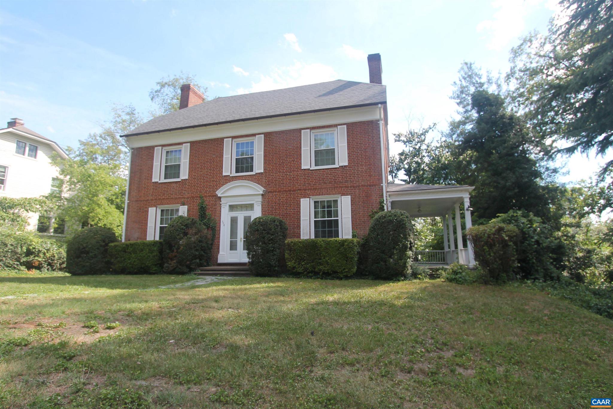 Stately brick home in a highly desirable UVA location near Scott Stadium, offering timeless character and endless potential. Situated on a spacious yard with off-street parking and a one-car garage, this classic residence features hardwood floors, plaster walls, a charming side porch, a rear screened porch, and a walk-up attic. Recent improvements include a roof, gutters, and hot water heater all less than five years old, along with updates to portions of the plumbing, windows, electrical panel, and electrical service. Gas heat and gas hot water. No central air conditioning. All appliances convey, including washer, stove, microwave, and two refrigerators (one located in the basement). Property is being sold As-Is, Where-Is, strictly, with some personal property to remain. A rare opportunity to update and customize a well-built home in one of Charlottesville's most sought-after locations.,Fireplace in Living Room
