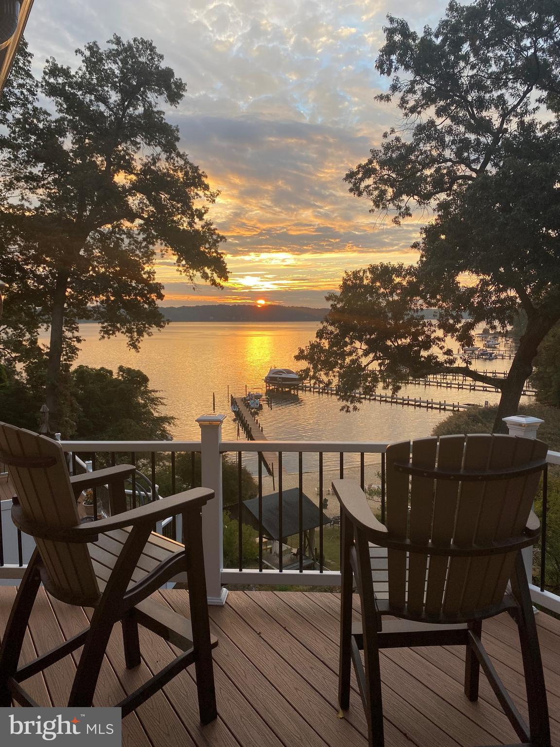 Priced to SELL! Owners found dream home and are ready to move on! Perched above the Severn River with breathtaking water views, this one-of-a-kind property offers a flexible lifestyle design that is hard to find in today’s market. Whether you are searching for multi-generational living, a second home near the Naval Academy, income potential, or simply a unique space to gather and entertain, this home delivers endless possibilities.The upper level features warm pine flooring, white kitchen cabinets, granite countertops, recessed lighting, and an open feel with multiple sliders designed to capture the river views and refreshing breeze. Two bedrooms and two full baths are located upstairs, along with convenient laundry facilities. Step outside and enjoy the incredible scenery from one of THREE full-sized decks or the charming side porch.The versatile middle level offers the perfect gathering space for entertaining, relaxing, or creating additional living space. With heat, air conditioning, a powder room, bar area, and two-car garage functionality still available, the options are endless.The lower level provides exceptional flexibility with private living space ideal for an in-law suite, guest quarters, home office, rental opportunity, Airbnb potential, or even a separate retreat for Naval Academy plebes while the family enjoys the upper levels. A second laundry area adds convenience and functionality. Enjoy community amenities including a beach area, boat ramp, and the Chesapeake Bay lifestyle without direct waterfront taxes. Conveniently located near Annapolis, the Naval Academy, Blue Angels shows, boat shows, waterfront dining, parades, and all the excitement downtown Annapolis has to offer. This is more than a home — it’s a lifestyle opportunity with unforgettable views and flexible living spaces designed for the way people live today.
