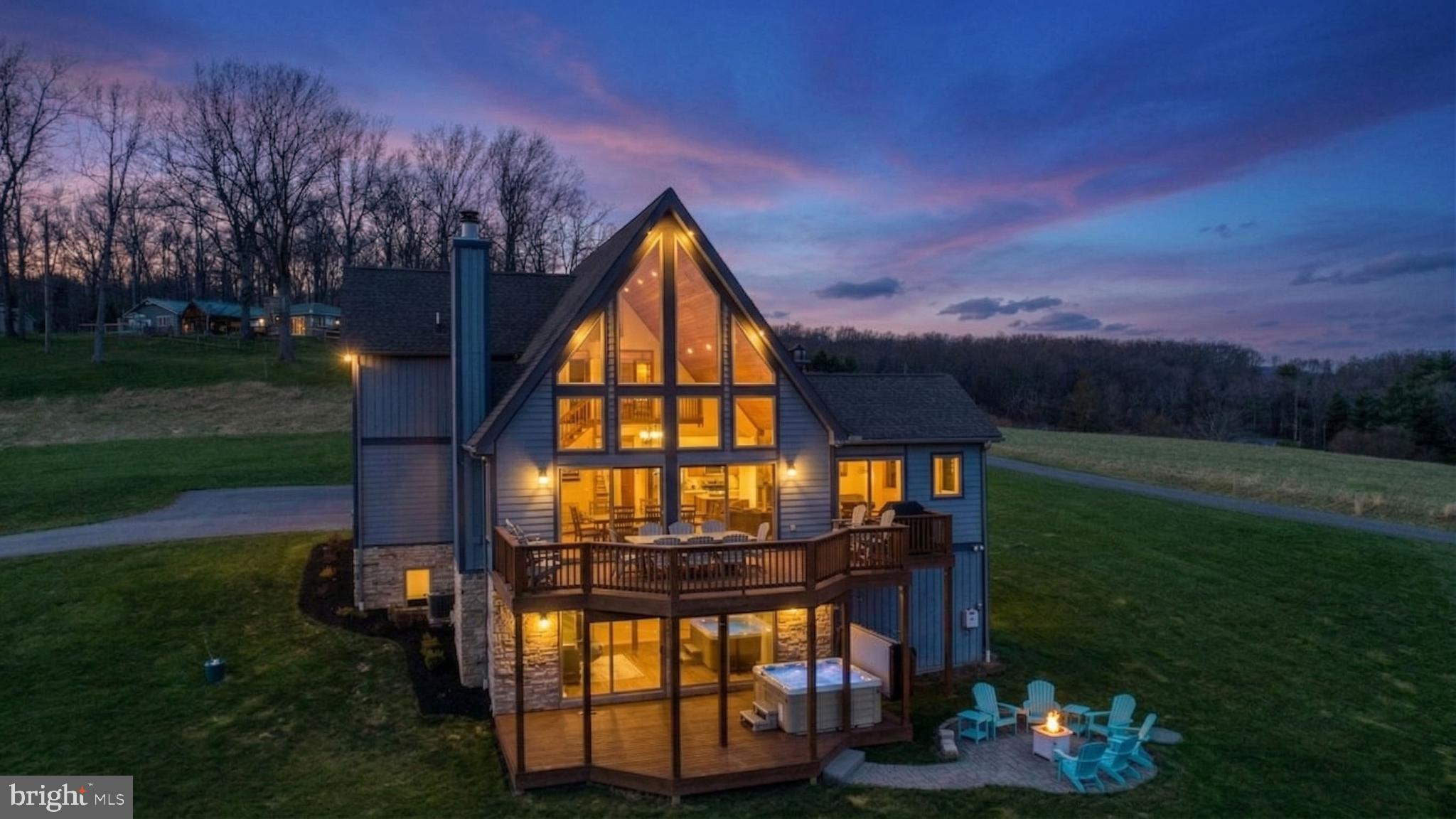 Welcome to “Hillside Haven,” a beautifully appointed mountain retreat nestled in the highly sought-after Waterfront Greens community at Deep Creek Lake. This exceptional home offers incredible views overlooking the lake and the private par-3 community golf course at Waterfront Greens . Whether you are looking for a vacation getaway, second home, or investment property, this home has many of the amenities you are looking for here at the lake!  Step inside to an inviting open-concept living area highlighted by a wood-burning fireplace and expansive windows with eastern exposure. The spacious layout is designed for gathering where you can enjoy multiple living areas and a fully equipped kitchen, perfect for entertaining guests. The lower-level game room provides endless entertainment with a pool table, lounge space, and wet bar.  Outdoor living is just as impressive, with a private hot tub, fire pit, and ample seating areas to relax and take in the peaceful surroundings.  Located within Waterfront Greens, you will enjoy access to a wide array of community amenities including lake access, swimming docks, a par-3 golf course, mini golf, tennis and pickleball courts—all just moments from your doorstep. This home has seen many recent renovations including bathrooms, kitchen, exterior paint, flooring, furnishings, and much more! “Hillside Haven” is more than a home—it’s a turnkey mountain retreat offering comfort, recreation, and lasting memories. Call today to schedule a private tour!
