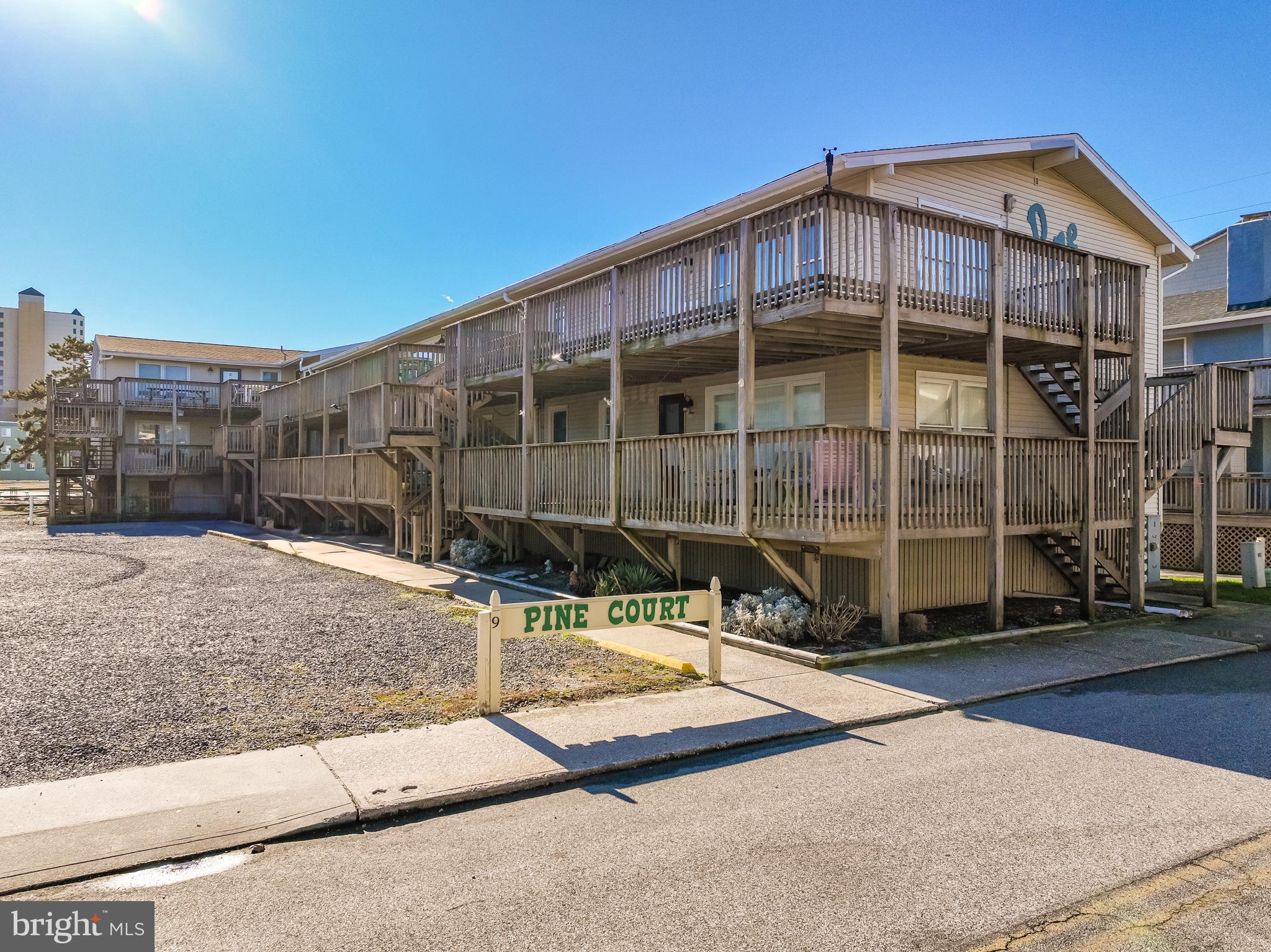 *Price Improvement* Pine Court-nestled in the heart of Ocean City, MD. This three-bedroom, two-bathroom beach retreat offers the perfect combination of charm, convenience, and coastal living. Centrally located just a short stroll from Seacrets Jamaica, USA, and other popular attractions, the property is part of a very small boutique building, ensuring a quiet and exclusive atmosphere. Inside, the spacious layout includes three comfortable bedrooms and two beautifully updated bathrooms with stylish finishes. The bright and airy living area is designed with coastal charm, offering plenty of room to relax and unwind. The well-equipped kitchen features updated appliances, ample cabinetry, and a breakfast bar, making it perfect for preparing meals or entertaining guests. Step outside to enjoy your over-sized private balcony, where you can soak in the ocean breeze and views of the surrounding area. The property includes 2 parking spots and a 12x6 storage shed. Large enough to store all of the family's beach cruisers and surf toys. All this for your added convenience and is just steps from the sandy beach and Ocean City's famous boardwalk. With its boutique feel and limited units, the building provides a quiet and personal beach experience.  Located close to live music, dining, and nightlife at other local venues, this retreat is ideal for those who want to be at the center of it all. The low-maintenance HOA covers essential amenities, community shared Hot Water heater and building upkeep, making it a hassle-free choice for a vacation home or rental investment. Pine Courts strong owner run assoc. has stayed on point with building updates and financial reserve funds are up to date. This charming property is a rare find and an incredible opportunity to own a slice of Ocean City paradise, all being a stones throw from your beach towel! Now is the time to “Unlock the Beach Lifestyle-Your Home Awaits"