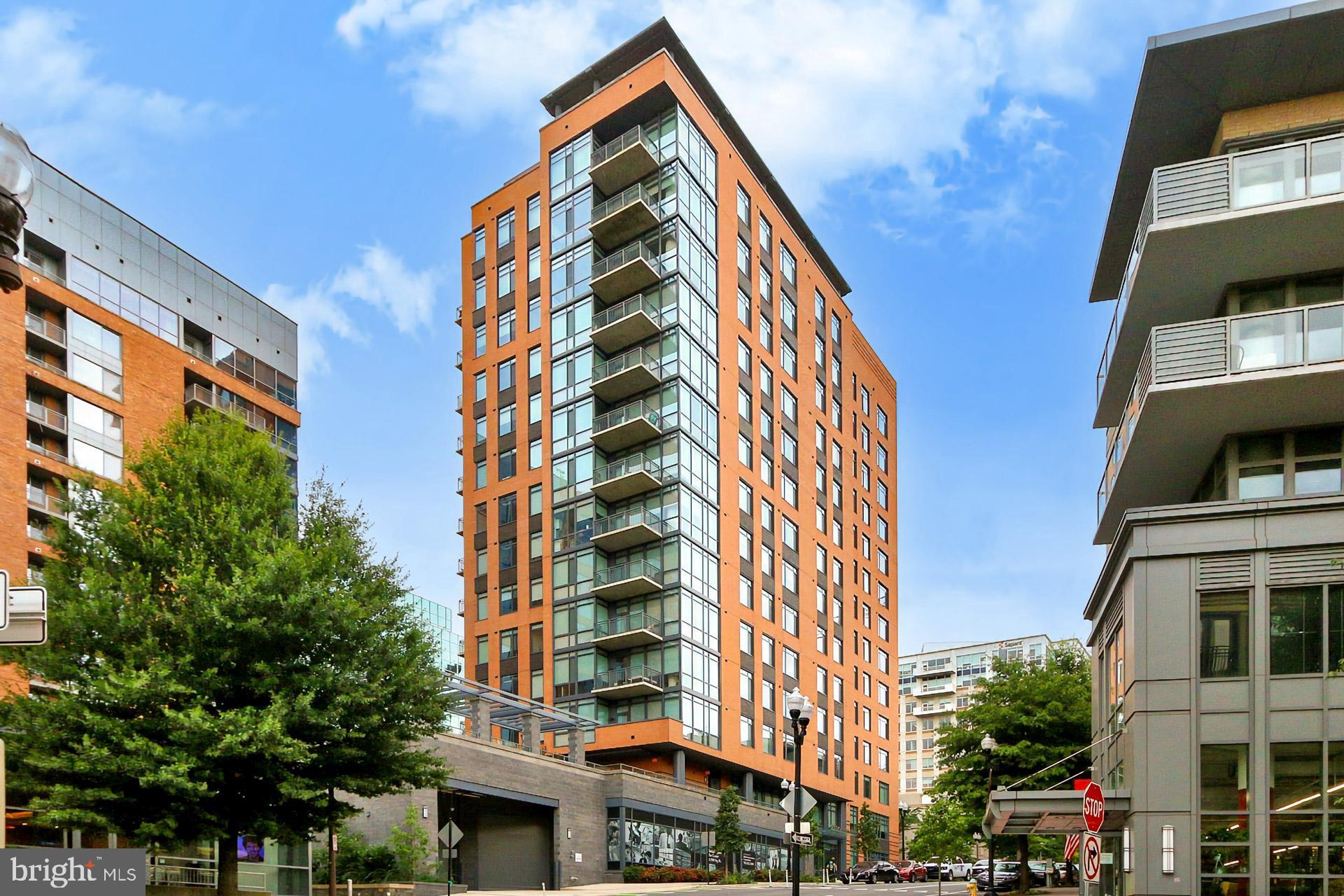 Luxury 1-Bedroom + Den Condo with 1.5 Baths in the Heart of Arlington

Experience the ultimate in modern living at 2000 Clarendon—a rare corner unit featuring soaring 11-ft ceilings, abundant natural light from numerous windows, breathtaking views of the Rosslyn skyline and nearby parks, and high-end designer finishes throughout. This sophisticated space offers a spacious bedroom and a versatile den, perfect for a home office or guest suite.

The chef’s kitchen is a true showstopper, boasting custom 42” shaker cabinets, quartz countertops, a stunning oversized island, and premium stainless steel appliances—ideal for both everyday living and entertaining. Step onto your private balcony to take in the vibrant Clarendon skyline, perfect for morning coffee or evening relaxation. Inside, a custom walk-in closet provides maximum storage, while an in-unit washer and dryer add everyday convenience. Additional storage is included, and an assigned garage parking space ensures effortless city living.

Beyond the unit, residents enjoy resort-style amenities, including a pool, fitness center, and clubhouse. The condo fee covers gas, water, trash, sewer, and more, offering peace of mind and exceptional value. The location is unbeatable—just two blocks from the Courthouse Metro (Silver/Orange lines) and steps from Arlington’s best dining, shopping, and entertainment.

With its rare combination of luxury, location, and lifestyle, this condo is a must-see. Schedule a private tour today before it’s gone!
