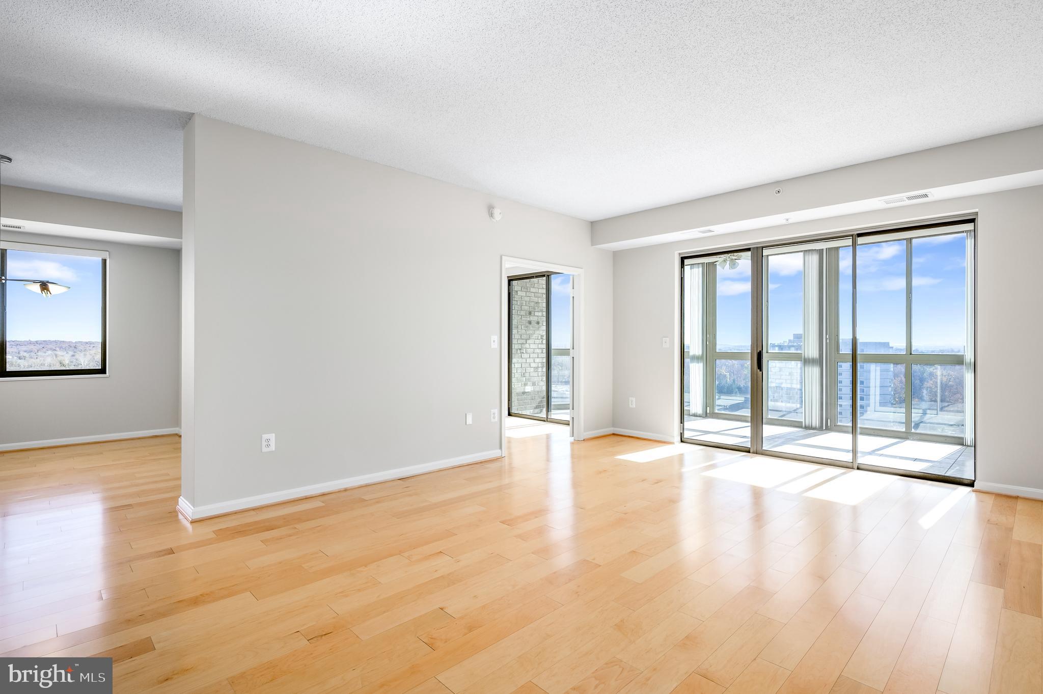 Welcome to an exquisite residence at the popular 55+ community of Lansdowne Woods, where elegance meets comfort in a home that offers breathtaking panoramic views of the Potomac River and the surrounding community. This spacious 1,720 square foot unit, thoughtfully designed with 3 bedrooms and two and one-half bathrooms, invites you to experience a lifestyle of sophistication and ease. Step inside to discover a harmonious blend of modern updates and timeless charm. The updated natural maple hardwood flooring and ceramic tile provide a warm and inviting ambiance. The modern kitchen boasts sleek appliances and plenty of cabinet and counter space, ensuring that your culinary adventures are as delightful as the views. Updates include: A/C replaced 2018, Furnace 2022, Refrigerator 2018, Microwave 2021, Dishwasher 2020, Vinyl flooring in bathrooms updated in 2015. Beyond the confines of your home, indulge in a plethora of amenities designed to elevate your living experience. Enjoy the tranquility of a common garden, walking trails, community bus, clubs and activities and more. For those with interest, a gym, tennis court, pool, sauna, fitness room, theatre, library, art studio and pickleball courts await. The property also features a billiards room, ceramics studio, hair salon and an on-site restaurant for your dining pleasure. You will enjoy the assigned parking space # 48 in the garage with indoor building access.  Storage bin P1-53 and parking space #48 included in lease.