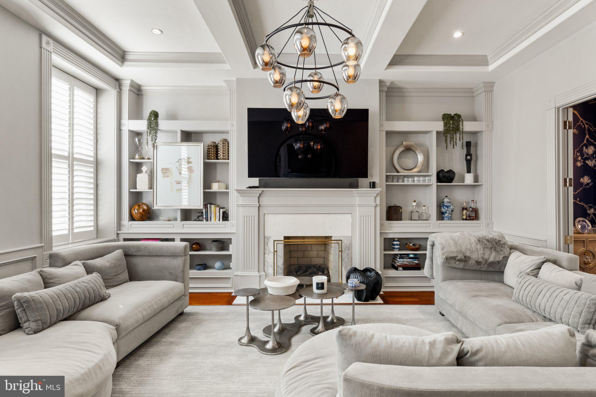 On a quiet, tree-lined block in Philadelphia’s storied Washington Square West, 1013 Clinton Street offers a rare combination of architectural scale and thoughtful interior design. Spanning over 6,000 square feet across five levels, this 20-foot-wide residence was masterfully reimagined by Widell + Boschetti, pairing grand proportions with refined, livable interiors.

The first level unfolds with an open living and dining rooms both anchored by a gas fireplace and framed by French style doors leading to a private courtyard patio providing an elegant extension of the living space. A guest powder room sits just off the main entertaining areas, while the eat-in gourmet kitchen features a walk-in pantry and an additional half bath.

Upstairs, the second floor is designed for everyday living and retreat. A warm family room with built-ins and fireplace includes a cleverly concealed full bath, allowing the space to function as a guest suite when needed. The primary suite occupies the remainder of the level, defined by soaring ceilings, a fireplace, and a generous dressing room with two walk-in closets and a washer/dryer. The spa-like bath is finished in marble with heated floors, double vanity, walk-in shower, and freestanding soaking tub.

The third floor offers another bedroom suite with dressing room and private bath, along with two additional bedrooms and a hall bathroom. Above, the fourth level provides a spacious bedroom suite with a glass-enclosed shower and single-vanity bath—ideal for guests, an au pair, or a quiet home office retreat.

A finished lower level expands the living space with a large playroom, den, or media room, along with a laundry room and ample storage.

Completing the offering, two parking spaces are available to lease just one block away, an uncommon convenience in this historic neighborhood.

A home of remarkable width, scale, and design pedigree, 1013 Clinton Street blends classic Philadelphia architecture with elevated modern living in one of the city’s most coveted residential neighborhoods. The Seller will provide 1-year prepaid parking for one of the spaces.