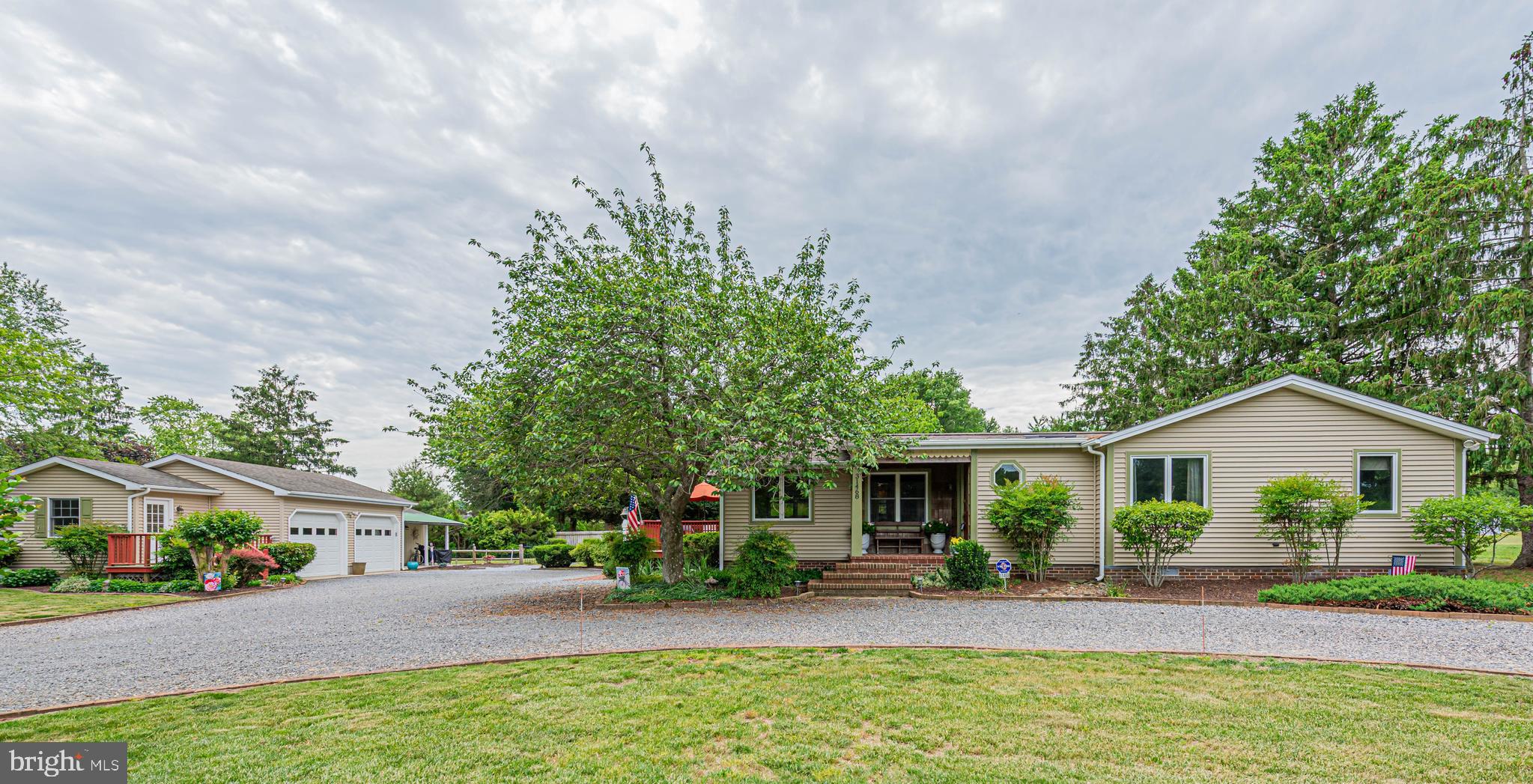 Welcome to 31468 Wingate Rd in Dagsboro, a beautifully maintained 3-bedroom, 2-bath coastal cottage offering the perfect blend of charm, functionality, and flexibility. This inviting home features warm bamboo flooring throughout the main living areas and hallway, with rich walnut flooring in the bedrooms, creating a cozy yet refined feel. Enjoy peaceful mornings on the welcoming front porch and effortless outdoor living with a spacious deck and fully fenced backyard—ideal for entertaining, pets, or relaxing. The 2-car garage is a standout feature, complete with an attached office and studio space equipped with a mini-split system and additional electrical circuits already in place for someone to convert the studio into an efficiency unit (buyer to verify permitting and approvals). The home is enhanced by quality Andersen windows, allowing for abundant natural light and energy efficiency throughout. Thoughtfully maintained landscaping and mature trees add privacy and curb appeal, while the peaceful setting offers a true coastal lifestyle retreat. Conveniently located approximately 15 minutes from the beaches, dining, and shopping of Bethany Beach, this home offers peaceful living with easy access to Delaware’s coastal attractions. A rare opportunity with versatile bonus space, character and coastal charm!