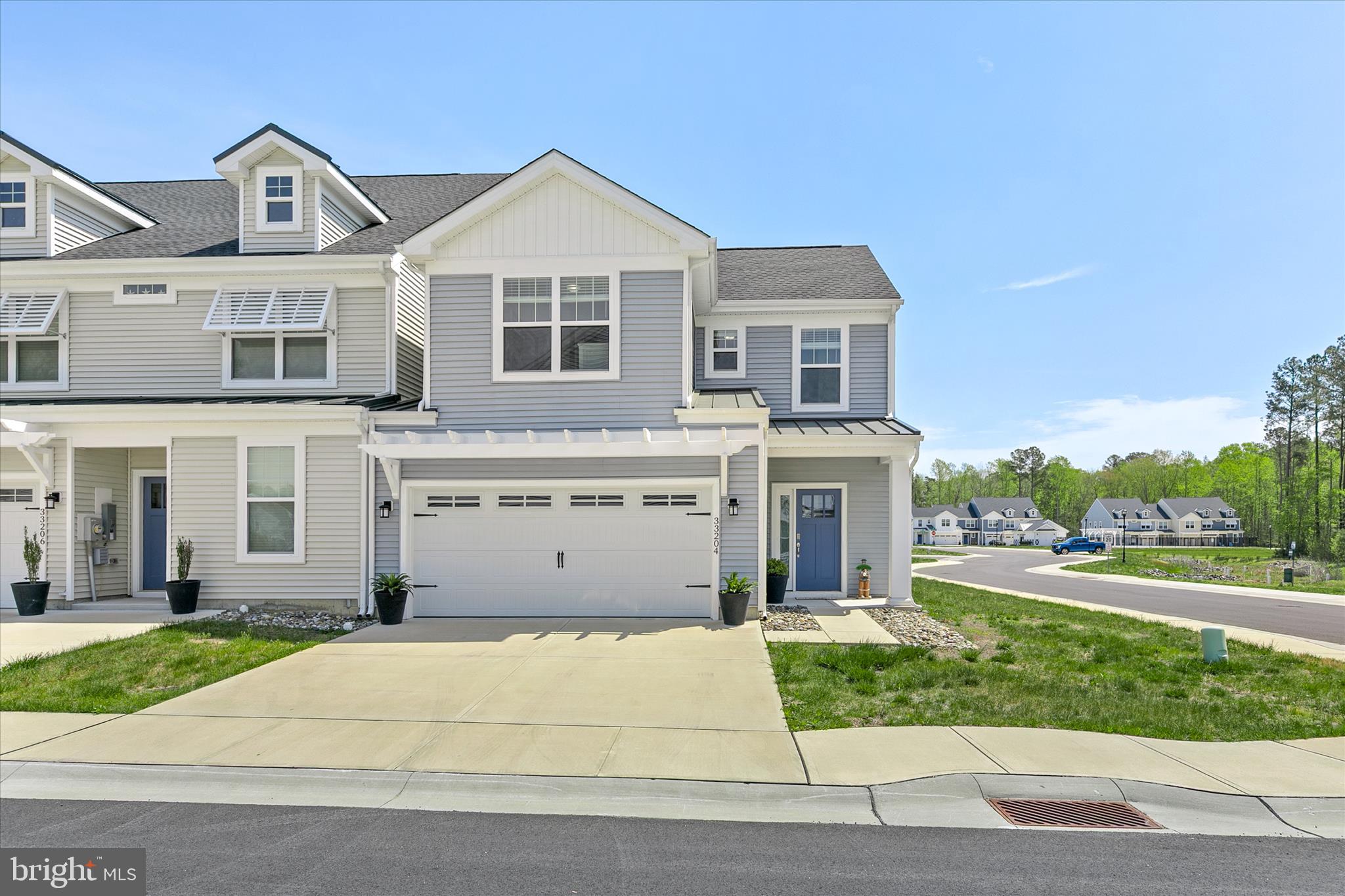 This beautifully furnished 4 bedroom, 2.5 bath coastal style end unit villa is move in ready and set to be enjoyed for Summer 2026.  Situated on a desirable corner homesite, this home offers low maintenance living with lower condo fees. The first floor features an open-concept layout designed for gathering and everyday living, highlighted by a spacious kitchen with a large island, stainless steel appliances, and granite countertops, A separate dining area provides additional space for hosting, while the first-floor primary suite includes a walk-in closet and private bath. Upstairs, you will find a versatile loft area, three generously sized guest bedrooms, and a full bath. The home also includes a two-car garage, adding everyday convenience and extra storage for all your beach gear.  Step outside to a concrete patio, perfect for enjoying quiet evenings after a day at the beach. Located just minutes from Bethany Beach and Fenwick Island, Friendship Creek offers convenient access to coastal dining, shopping, local attractions, and nearby beaches and bays. The community features an outdoor pool and dog park, adding to its appeal for both year-round living and seasonal enjoyment.