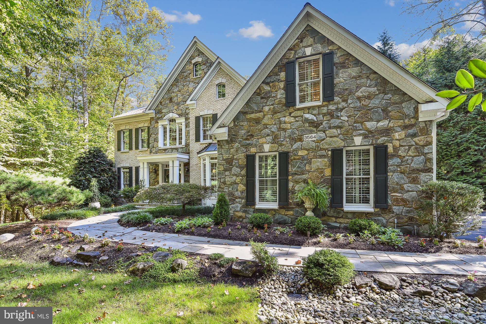 New  price! VA BUYERS- SELLER HAS ASSUMABLE 2.25% LOAN. Straight out of Beautiful Homes and gardens | Amazing Davidsonville property ...Meticulously maintained this Winchester built 4-5bedroom, 4.5-bathroom home in Davidsonville’s coveted Ashley neighborhood is nothing short of impeccable. Serenely surrounded by trees offering the utmost private tranquil setting. Ideally located within a community with the convenience of quick access to Rt. 50, and easy access to nearby shopping and area restaurants.  Professionally landscaped this 1-acre lot includes an in-ground heated saltwater pool with water fall feature, magnificent specimen tress  and over 7,000 sq ft of exquisitely finished living space, loaded with upgrades. This home boasts polished elegance, superior craftsmanship, sophisticated detail, and design-inspired features in every room! Hardwood floors, custom moldings, exquisite light fixtures, plantation wood shutters, soaring ceilings, and lofty windows enhance the common areas. The first floor features an office/study appointed with custom cherry-built ins, a large open dining room with a beverage service area and a gourmet custom kitchen featuring numerous windows overlooking the private backyard oasis.  Entertaining is made seamless with an oversized island, eat- in casual dining space, updated stainless appliances, a gas cooktop and a dedicated pantry. An impressive two-story family room featuring a soaring stone gas fireplace, formal living room, additional staircase, mudroom/drop area, and half bath complete the main level. The upper level offers a luxurious spacious primary suite , well-appointed with built in entertainment unit, sitting area fabulous garden views, and two walk-in , love the creative closet built-ins. Additional upper bedrooms include 2 large bedrooms with a Jack and Jill bath, a 4th bedroom with an ensuite bathroom, plus the convenience of 2nd floor laundry. Travel downstairs and the walk out basement could serve as a fabulous au pair suite with a full bath, large family recreation space,  a separate exercise room with closets could be perfect for guest room.  Additionally, the lower level boasts a spacious storage room/ utility room. The exterior is a complete private outside oasis and will satisfy all your entertaining desires with an expansive paver stone patio, accessed by the low maintenance trex deck.   Premium lot location backing to community preservation area and across the street, as well.  The exterior features extensive hardscaping w stone stair steps leading to the shed, native landscaping surrounding the beautiful waterfall pool, exterior lighting, a playset for the little ones and fenced backyard surrounded by nature!  All in all, this home is truly a must-see for anyone who appreciates luxury living at its best! Blue Ribbon Davidsonville School!
Its time to escape to a secluded haven right in your own home, unwind in a peaceful setting filled with the tranquil sound of the waterfall and chirping birds.  Enjoy the warm months ahead while relaxing by the heated pool,  surrounded by  the  picturesque gardens and  scenery. An idyllic retreat for hosting memorable  family gatherings and friendly get togethers.