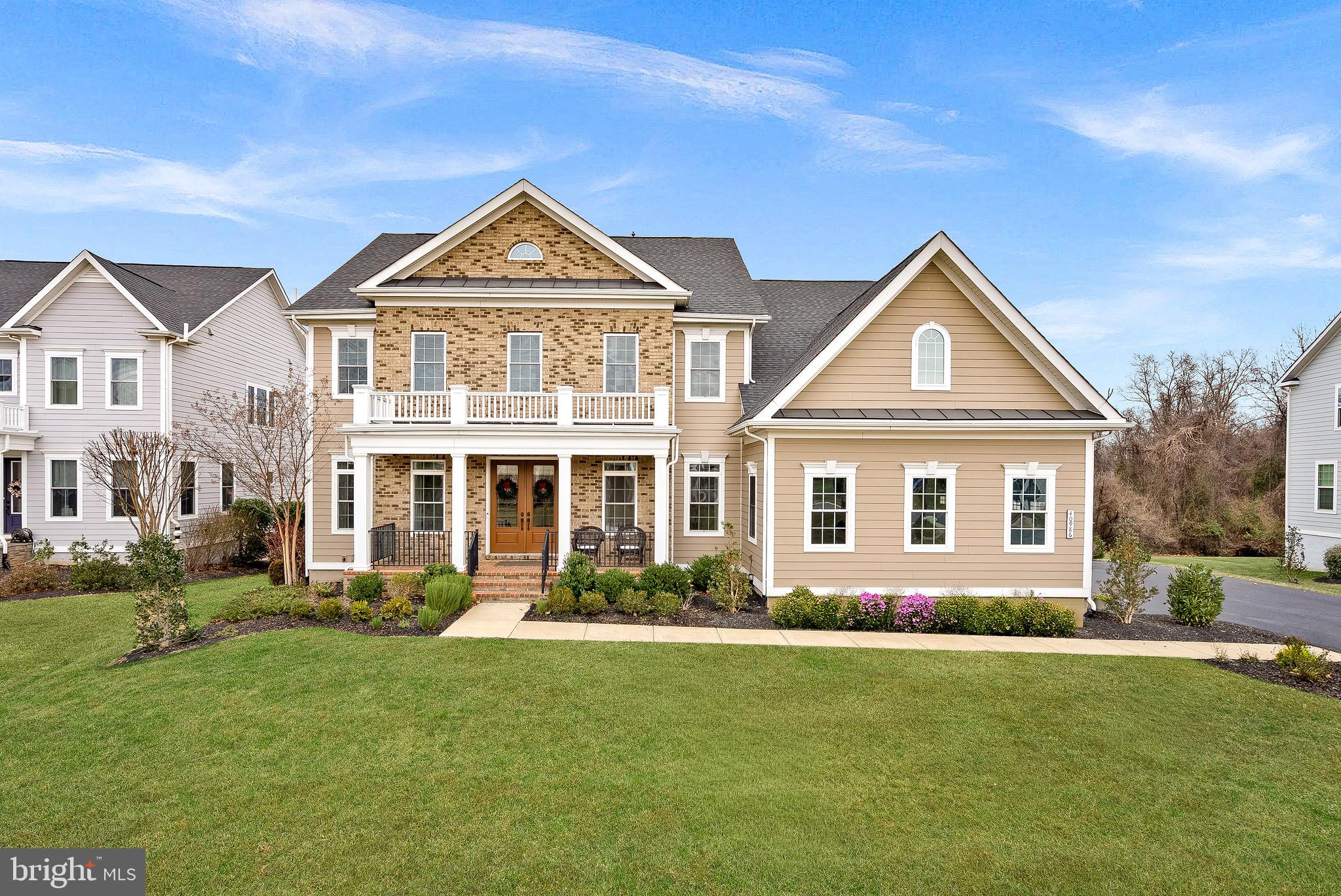 Welcome to an extraordinary luxury residence in Willowsford, one of Northern Virginia’s most coveted lifestyle communities—where refined design meets resort-style living. Built by NV Homes, this stunning modern floor plan has been thoughtfully elevated with designer finishes throughout and offers nearly 7,000 square feet of impeccably curated living space, a three-car garage, and a private, tree-backed lot.

From the moment you arrive, the home impresses with rich engineered hardwood flooring across the main level, elegant arched doorways, custom drapery, updated lighting, and built-in speakers on both the main and lower levels. The dramatic two-story family room serves as the heart of the home, featuring a soaring wall of windows and a breathtaking two-story stone fireplace flanked by custom built-ins. A second-level walkway overlooks the open floor plan below, adding architectural drama and scale.

The welcoming foyer opens to a light-filled dining room with tray ceiling, chair rail molding, and designer lighting—perfect for formal gatherings. A dedicated music room offers an elegant space for a grand piano or intimate entertaining. The main level also includes a full bedroom and full bathroom, ideal for guests.

At the center of the home is the gourmet kitchen, complete with double islands, glass tile backsplash, high-end stainless steel appliances, gas cooktop, walk-in pantry, and wine refrigerator. The kitchen flows seamlessly into a custom mudroom with built-ins and abundant storage, while dual staircases provide effortless access to the upper level.

Upstairs, every bedroom features its own upgraded en-suite bathroom. The luxurious primary suite offers a private sitting area with access to a balcony overlooking the backyard, a tray ceiling, and an expansive walk-in closet with custom organizers. The spa-inspired primary bath includes a soaking tub, dual vanities with additional storage, a glass-enclosed shower, and a separate water closet.

The finished lower level spans over 2,200 square feet and is designed for entertaining and extended living. Highlights include a full bar with dishwasher, stainless steel sink, and wine refrigerator, along with space for a media room, gym, and additional living areas. A legal bedroom, full bathroom, and multiple storage rooms complete this impressive level.

Outdoors, the private lot backs to mature trees, with the backyard thoughtfully cleared and expanded to maximize usable space. A massive wraparound patio creates the perfect setting for outdoor entertaining, dining, and relaxation.

Life in Willowsford is unlike anywhere else. Residents enjoy two clubhouses with resort-style pools, a fitness center, splash park, zip line, miles of scenic trails, sports courts, campsites, picnic areas, sledding hills, dog parks, fishing ponds, and an archery range—creating a vibrant, connected lifestyle rooted in wellness and community.

Adding to the magic of the community is the Willowsford Conservancy, which manages more than 2,000 acres of preserved woodlands, ponds, streams, and meadows through thoughtful, sustainable land stewardship. Residents enjoy access to miles of nature trails, a working farm, and a beloved seasonal farmers market—offering a rare opportunity to live surrounded by nature, nourishment, and a true sense of connection to the land.

This is more than a home—it’s a place to gather, celebrate, and create lasting memories in one of Northern Virginia’s most extraordinary communities.