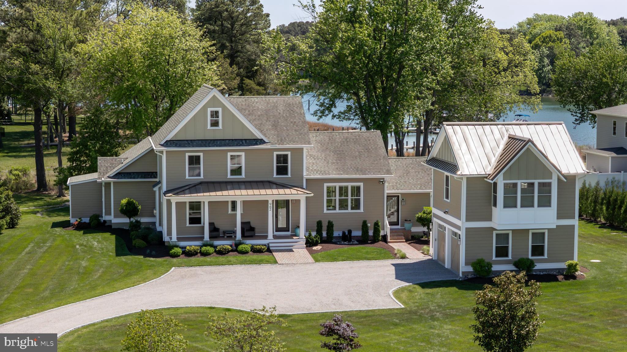 This exquisite in-town St. Michaels coastal-style waterfront is a designer’s dream home. The 3,300 sq, ft. residence shows like a new model home with an unparalleled quality of finishes and level of design. Located in desirable San Domingo Cove, the community enjoys protected natural open space, beautiful water features and immediate access to the ever-popular St. Michaels Nature Trail offering an easy walk or bike ride to the wonderful shops, restaurants and amenities of Historic St. Michaels. The residence features four private bedroom suites, a den, 4.5 spa-like bathrooms and a 2-car garage with an adorable guest residence with outdoor deck above. A 1.5-acre manicured lush, landscaped setting features a beautiful saltwater, waterside pool, substantial outdoor entertaining space and a firepit. The property also features a custom, stone entrance with lighting, a tree lined Belgian block bordered driveway and a fully irrigated sprinkler system. The home enjoys a bright, sunlit, open floor plan, sophisticated finishes, tall ceilings, a main level waterside primary suite, and a beautiful kitchen designed for entertaining that includes quartz counters, a glass subway tile backsplash and stainless appliances. The living room features a fireplace wall with limestone surround, custom cabinetry and floating shelving. The home’s appointments include; high-end bath fixtures and lighting by Restoration Hardware, beautiful bamboo hardwood flooring, custom frameless glass shower enclosures, an upgraded sound system on the main level and pool entertainment deck and automated blinds. The dream garage is temperature controlled, has epoxy flooring and a custom cabinetry and storage system. Enjoy boating on the picturesque San Domingo Creek and the connecting, beautiful tributaries via the dedicated pier that is shared with the adjacent neighbor that features, an approximate 4 feet MLW water depth, a 10,000 lb. boat lift and a floating pier for your kayaks. Your family and guests will enjoy the convenience and lifestyle of this coveted St. Michaels location and the waterfront living experience afforded by this exquisite residence.
**See the movie icon for the virtual tour and floor plans.