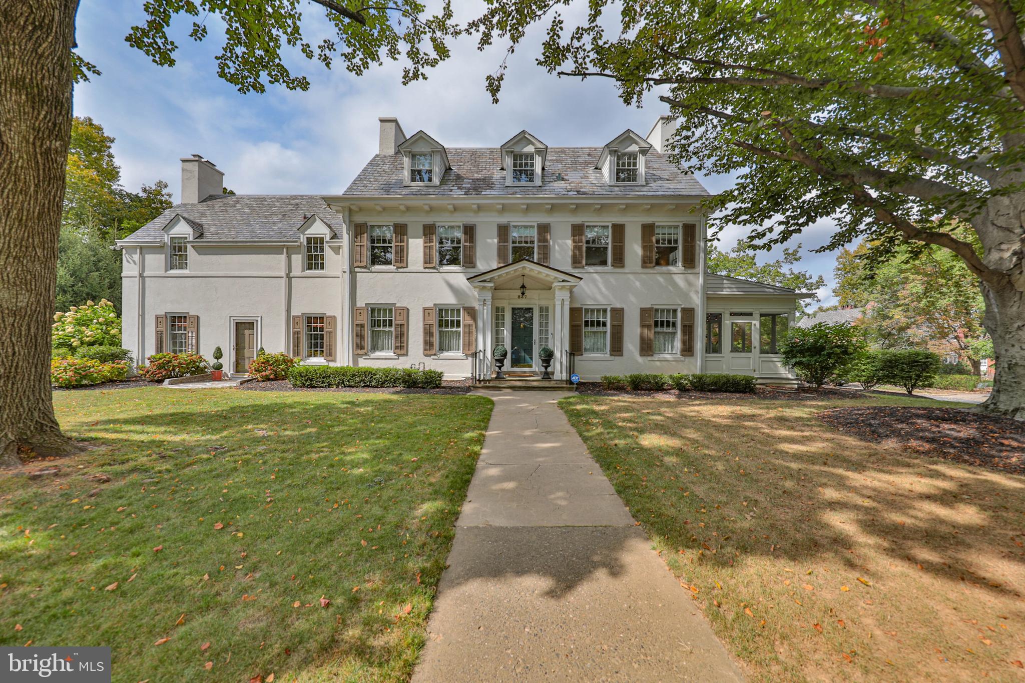A HOME THAT BRINGS ELEGANCE TO EVERY ASPECT OF LIFE! It’s a classically proportioned and appointed house that exhales sophistication and class, nestled in the old Rosemont section of Bethlehem. Built in 1928, this 5-BR, 4.5 BA masterpiece was completely renovated in 2022/2024. A grand, central foyer welcomes you into a sunlit living room on one side and a formal dining room on the other, both with elegant crown molding and natural wood floors. The living room features a fireplace with a ceramic tiled hearth and walls of built-in bookshelves for all your favorite books. Two sets of French doors open to a lovely, enclosed breezeway, perfect for cool summer nights or watching the colors of fall. The dining room connects to a spacious family room with fireplace, built-ins, and bay window. Any cook would love the kitchen, with Nero Marquina marble floors; custom tall wood cabinets; six-burner, stainless steel stove; stainless steel appliances; and a breakfast nook with built-in bench for cozy coffee breaks. A butler’s pantry is equipped with a sink, cabinets, and wine storage. The second floor is just as refined: The master ensuite has a gas fireplace, double vanity, marble floors with radiant heat, glass enclosed steam shower and a dressing room, two sizeable bedrooms with a Jack-N-Jill bath and a room with a wood-burning fireplace & bedroom complete the second floor. On the third is expansive wood beamed bonus room with adjacent bedroom and full bathroom, perfect for guests or extended family. Outside, large trees and manicured gardens frame the house while a full basement and two-car garage complete the picture.  Sellers are offering all the furniture and furnishings that were selected and purchased exclusively for this home and less than a year old.   THIS PROPERTY IS FIRST-CLASS INSIDE AND OUT – DON’T MISS IT!
