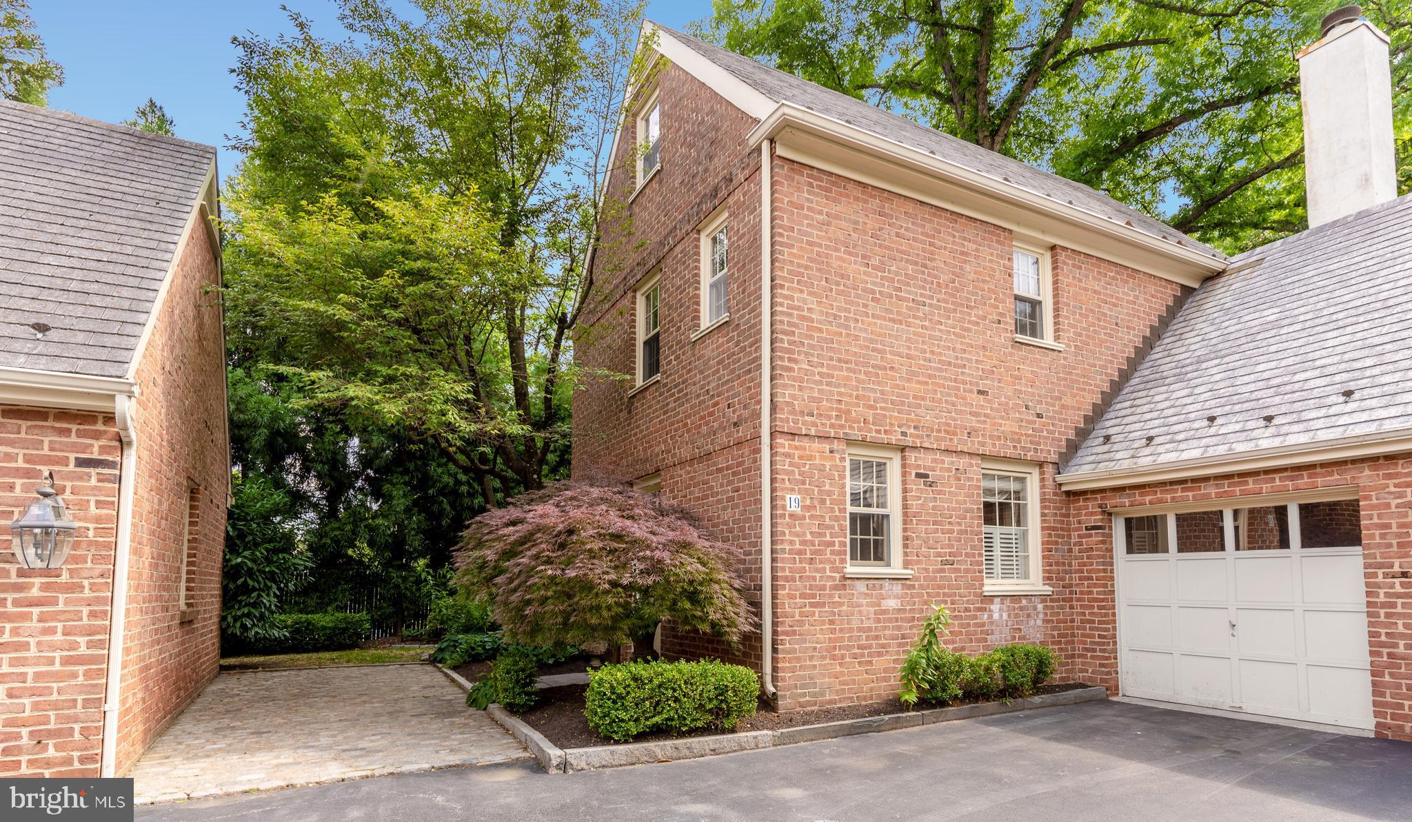 Enjoy extraordinary living in this elegant 2 bedroom 2 1/2 bath brick townhouse in desirable Thacher Court.  Walking distance to Haverford train station, Haverford shops, and Suburban Square.  A cobblestone courtyard leads you to the private entrance. Open the door to the first floor with beautiful hardwood floors and large windows that bathe the space in natural light. The living room features a gorgeous statement fireplace flanked by floor to ceiling bookshelves.  The inviting kitchen is outfitted with granite countertops, custom cabinetry and Bosch appliances. Glass doors off the dining room lead you to the flagstone patio and garden. The garden is a true oasis with rhododendron, lace cap hydrangea, tree peonies, and specimen plantings. Up the stairs you will find the spacious primary bedroom with Stark carpet, a wall of closets, and an ensuite bath with deep soaking tub. There is an additional bedroom on the third floor with a vaulted ceiling, built in shelves, and a full bath with skylight.  The finished basement offers bonus flex space ideal for an office or media room with separate laundry. Attached 1-car garage and an additional parking space.