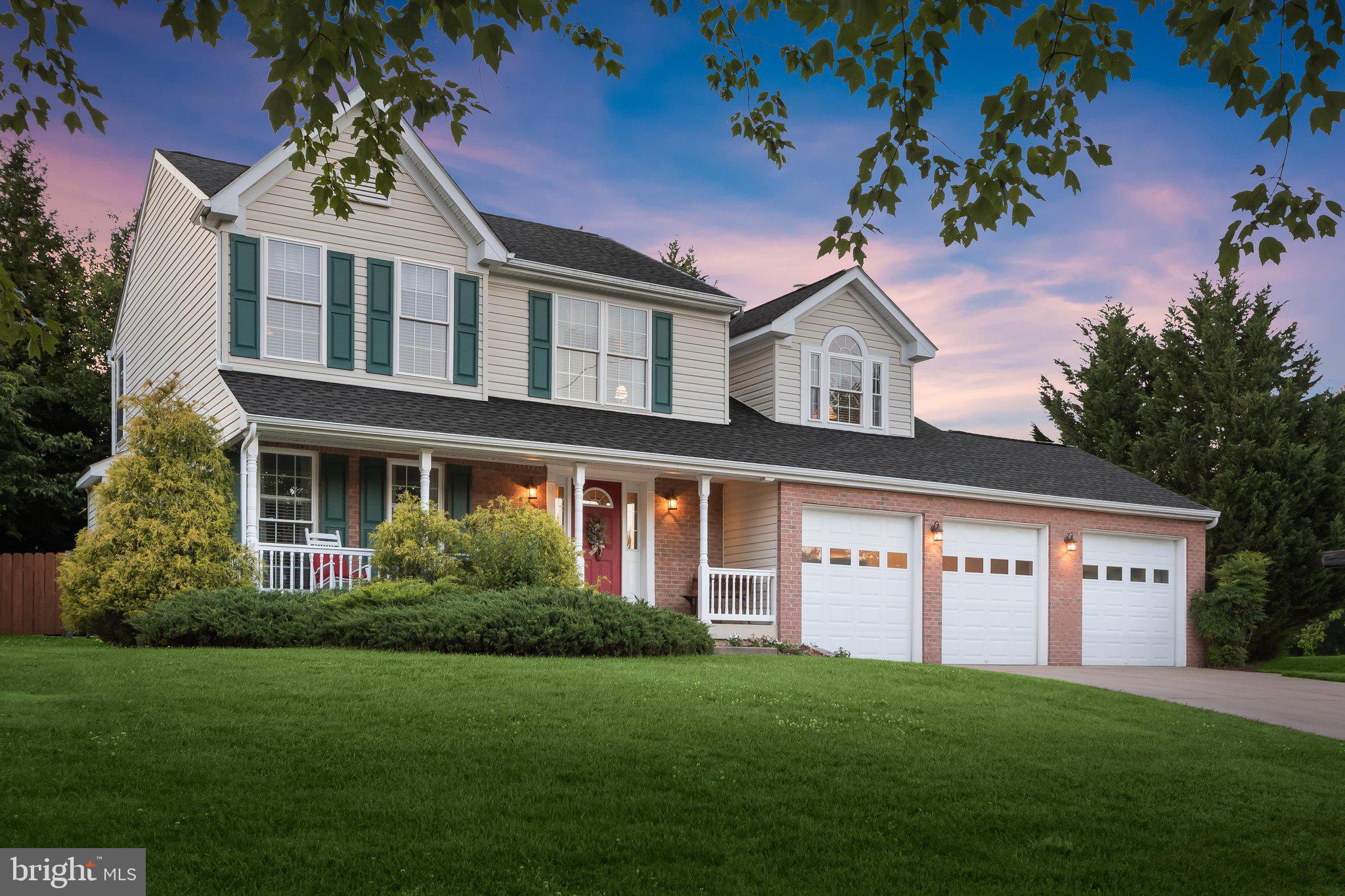 Enjoy spacious living in this meticulously maintained colonial, ideally situated on a premium lot in Ellicott City's popular Mt. Hebron community and offering three finished levels of living space. Numerous updates include the roof, bathrooms, low-energy windows, and abundant storage spaces throughout the home. A welcoming covered front porch sets the tone for the impressive interior. The main level features formal living and dining rooms enhanced with elegant accent molding. The spacious kitchen boasts granite countertops, a tiered island breakfast bar, and a bright breakfast area with direct access to the private patio. Adjacent to the kitchen, the inviting family room showcases a gas fireplace flanked by custom built-in bookcases. A convenient powder room completes the main level.  Upstairs, the luxurious primary suite features a soaring cathedral ceiling, sitting room, two walk-in closets, and a beautifully renovated en-suite bath with dual vanities, lighted mirrors, glass enclosed shower, and a jetted soaking tub. Three additional bedrooms and an updated hall bathroom complete the upper level.  The finished lower level offers exceptional flexibility with a bedroom, full bathroom, recreation room, extensive storage areas, and wide stairs leading directly to the backyard.  Enjoy the beautifully landscaped outdoor setting backing to mature shade trees. The expansive patio features stone retaining walls, a gas grill hookup, and plenty of space for entertaining. The fully fenced yard includes a large storage shed.  Additional highlights include a finished 3-car garage and a drop-down insulated, floored attic for even more storage. Ideally located near major commuter routes, shopping, dining, and entertainment, this exceptional home combines comfort, functionality, and convenience.