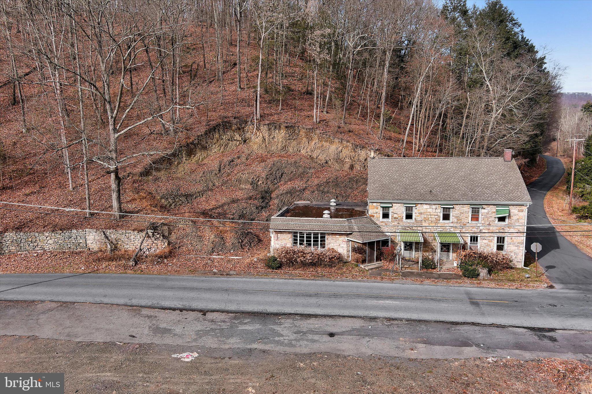This East Brunswick property includes approximately 12 acres and is the home of the historic Smith's Country Inn. Approximately 6 of those acres (located on one side of Church Rd) are zone commercial and completely flat for easy development.  This property was originally a stage coach stop back in the late 1700s where weary travelers would stop to resupply, rest, eat, and drink. The stone building has great bones and was formally a popular fine dining restaurant and bar. Currently gutted to the original log and stone. Utilities are off. The lot on the home side of the road is zoned agricultural preservation. With a vision and a plan you can bring this great property back to life!