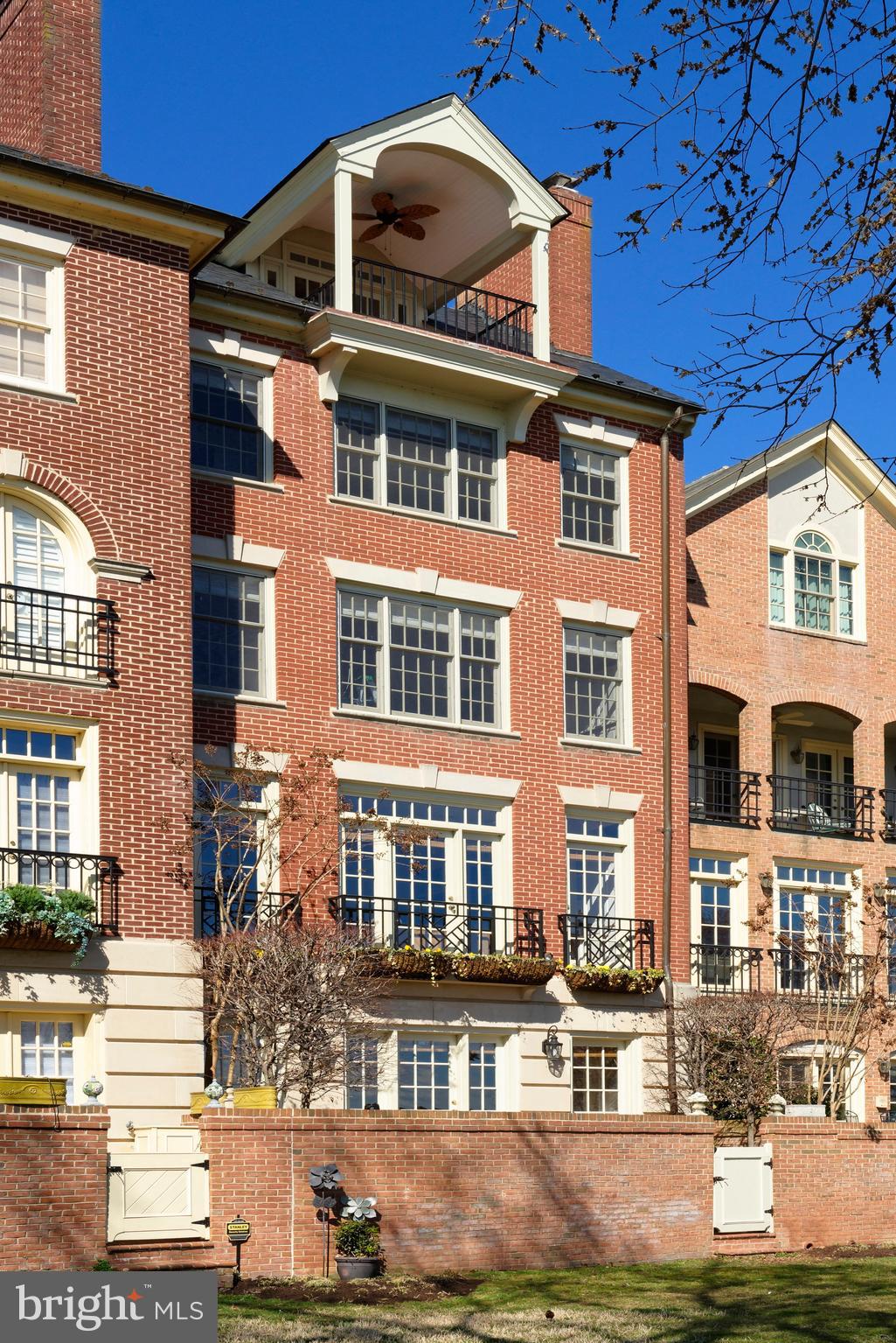 This handsome 5-story townhouse situated on the Potomac River is a dream come true for the discerning homebuyer seeking the finest luxury waterfront lifestyle in Alexandria. Exquisite living quarters and breathtaking views of the water and sunsets from every floor are your daily pleasure, in addition to the prized conveniences of a private 2-car attached garage for your vehicles and a RARE 35  boat slip for your vessel!Built in 1993, 22 Wolfe St boasts a prime location in the coveted Harborside neighborhood. The gracious interior is beautifully designed and well suited for all your needs, whether entertaining in the generously-proportioned main rooms or spending quiet time relaxing. Classic elements enrich the ambiance, such as extensive built-ins, tasteful moldings and millwork, 4 fireplaces, and rich hardwood floors.Formal living and dining rooms, and a fabulous uniquely-positioned riverside kitchen/family room on the home s second level afford perfect backdrops for hosting guests and relaxing with family. Gaze out at the Potomac while preparing meals in the elegantly-appointed chef s kitchen, styled with abundant wood cabinetry, all new stainless Viking appliances, and a charming open breakfast area. A wet bar and 300-bottle Subzero wine cooler located on level one allow easy serving of your favorite spirits, which can be enjoyed while chatting around the fireplace in the large open family room. A wall of glass doors lead out to the spacious and serene brick patio overlooking the gorgeous river, and the lovely lawn area.The peaceful upper levels house either 4 or 5 bedrooms, depending on how you utilize the space. The luxurious master suite with its own fireplace, hall of closets and ivory marble bath, along with a guest bedroom occupies the 3rd floor. Level 4 is comprised of an office/bedroom with fireplace and built-in workstation, and additional guest bedroom, both with en-suite baths. Perched on the top floor is a wonderful multipurpose room, currently used as an exercise room with a wet bar, an amazing balcony overlooking the river capturing a spectacular direct view of the U.S. Capitol building, and another bedroom and full bath in the rear. Step outside to sit on the lawn by the water or embark on your boat to set sail for the day. Truly one of a kind!