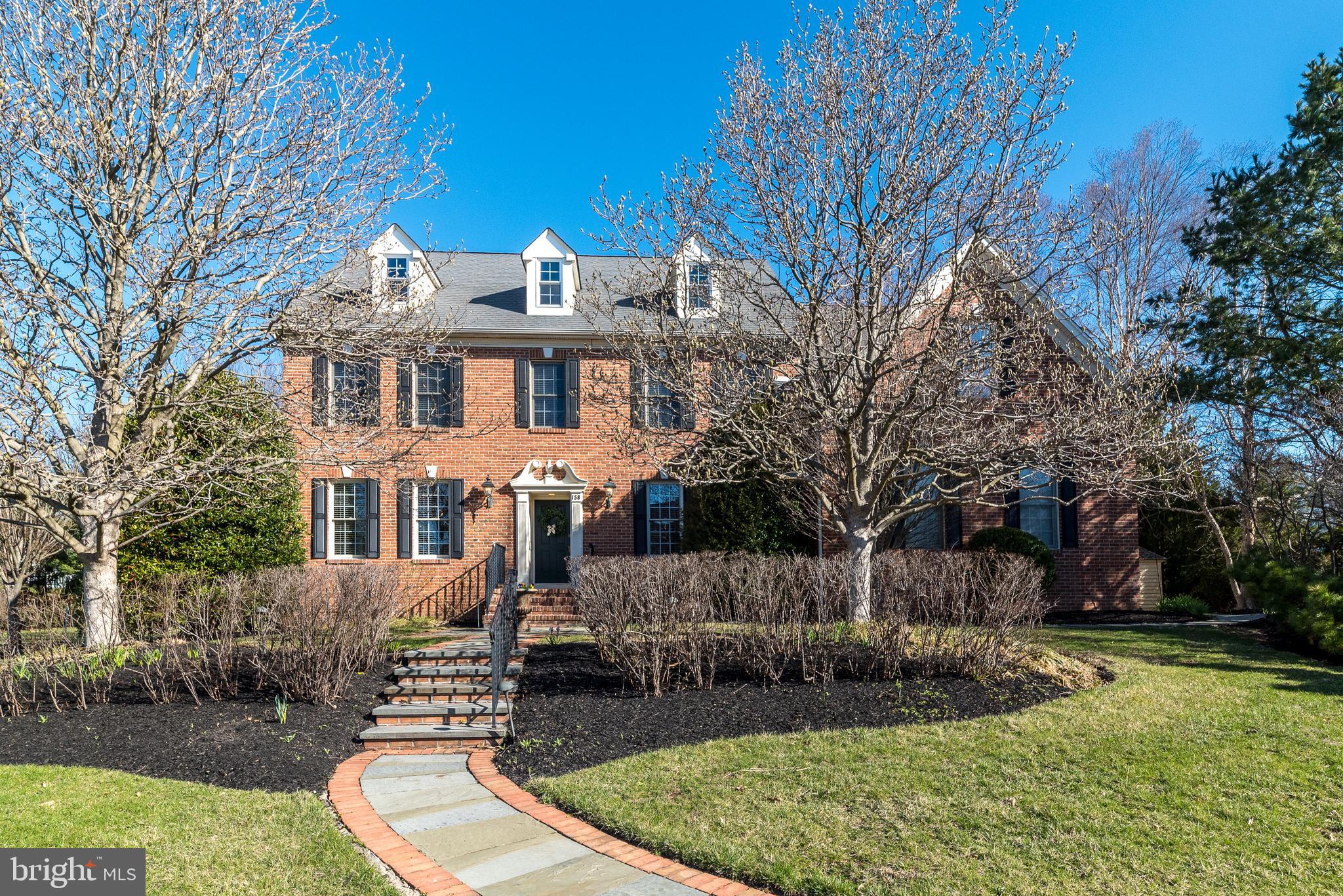 Welcome to this elegant home nestled in a stately neighborhood, offering timeless sophistication and comfort. The charming brick front and flagstone walkway lead you to a welcoming entrance, where you're greeted by a warm foyer with gleaming hardwood floors that flow seamlessly throughout the main level. Custom detailed molding, including picture frame accents, adds an extra layer of elegance to the space.
To the right of the foyer, through French doors, is a well-appointed office featuring wall-to-wall built-in bookshelves and more picture frame molding—ideal for a quiet retreat or professional workspace. To the left, the gorgeous living room boasts crown and picture frame molding, along with recessed lighting, creating an inviting space for entertaining. Passing through an archway adorned with a keystone, a nod to the home's Pennsylvania roots, you enter the bright and airy dining room. This space features a stunning tray ceiling and elegant picture frame molding, perfect for hosting dinner parties or family gatherings.
The gourmet kitchen is a chef's dream, with a large Bavarian soapstone island, solid cherry cabinetry, and top-of-the-line appliances, including a brand new, never-before-used Bosch double oven, gas cooktop, microwave, and a newer Miele dishwasher. The kitchen also offers granite countertops and a cozy breakfast area with a granite wet bar, wine rack, and large windows that bathe the space in natural light. A door opens to a large Trex deck with lighting (2018), ideal for outdoor entertaining. The two-story family room is a striking feature of the home, with a beautiful stone wood-burning fireplace and atrium doors leading to the deck. A tastefully decorated powder room and a convenient laundry room complete the main level. The second level is accessed by either the front or rear staircase and is freshly carpeted throughout. The primary bedroom retreat is a sanctuary, complete with a tray ceiling, spa-like bathroom with a Jacuzzi tub, plantation shutters, large corner shower, private water closet, and an exquisite custom walk-in closet. Three additional bedrooms, one with its own private bathroom, are generously sized.
Additional highlights include a walk-up to a large attic, a spacious basement with 9-foot ceilings and a full bathroom, a three-car side-entry garage with openers, new 2 zone HVAC system-2024, water softener, reverse osmosis system, PH neutralization, generator hook-up, lawn irrigation system.  The lovely 1 acre level lot is situated in a highly sought-after neighborhood within the award-winning Council Rock School District.
Spoil yourself with the luxury and comfort this home offers!