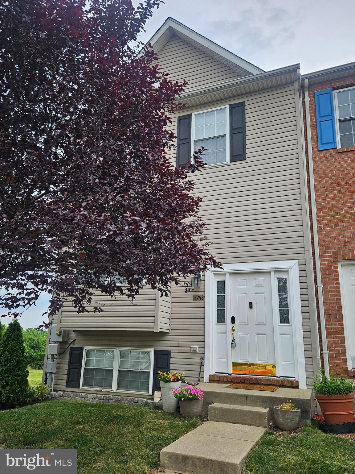 Welcome home to this beautifully maintained, move-in ready 4-bedroom, 2.5-bath townhouse located in a highly desirable neighborhood! Offering a bright, open floor plan filled with natural light, this home is perfect for both everyday living and entertaining. The spacious main level features durable tile and laminate flooring, an inviting living area, and a well-appointed eat-in kitchen boasting granite countertops, abundant cabinetry, generous storage space, and newer stainless-steel appliances, including a new 2026 stove, 2026 washer and dryer, microwave, and a dishwasher that's only six years old. Step outside to the oversized party-sized deck overlooking open common areas and a large green space—an ideal setting for relaxing or hosting family and friends. Upstairs, you'll find generously sized bedrooms and well-appointed baths designed for comfort and convenience. The fully finished walk-out basement provides exceptional additional living space, complete with a fourth bedroom, a full bath, and a spacious recreation or family room, making it perfect for guests, a home office, or multi-generational living. Additional updates include a roof that is approximately six years old. The HVAC system is approximately 20 years old and has been maintained.  Enjoy the convenience of two assigned parking spaces and outstanding community amenities, including a neighborhood pool. With its thoughtful updates, spacious layout, abundant natural light, ample storage, and prime location, this home offers the perfect combination of comfort, style, and value. Don't miss this exceptional opportunity!