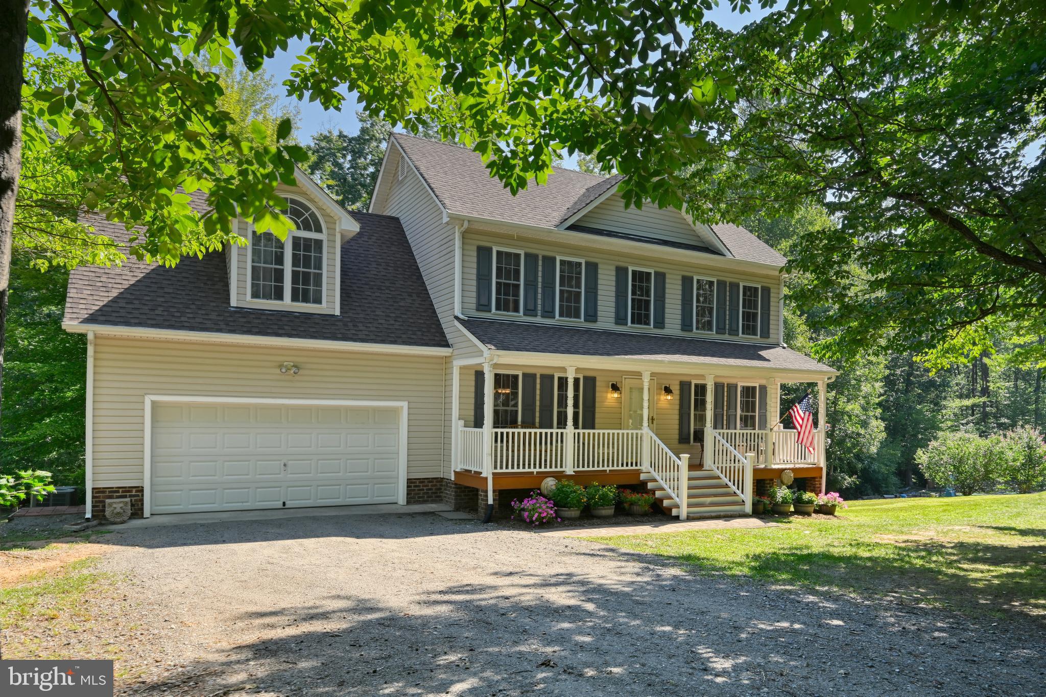 Bring the boats, golf carts, and the whole family—this is the complete Lake Anna package. Situated on a private 1.85-acre double lot with winter water views, this beautiful home offers over 3,000 finished square feet, a deeded boat slip on the private side of Lake Anna, and an incredible 40' x 30' climate-controlled detached garage on its own lot. Complete with separate electric service, a covered side overhang, 40x12 upper storage, and plenty of room to park and maneuver boats, trailers, golf carts, and all of your Lake Anna toys, it's the kind of setup every Lake Anna buyer hopes to find, but rarely does.

Inside, you'll find a spacious, thoughtfully designed floor plan that blends comfort with functionality. The main level features a welcoming family room with a gas fireplace, formal dining room, half bath, and an eat-in kitchen with a center island, stainless steel appliances, pantry, and breakfast area overlooking the backyard.

Upstairs, the primary suite has been beautifully updated with heated tile floors, dual walk-in showers, double vanities, and a walk-in closet. Three additional bedrooms, a full hall bath, and laundry area.

The finished walk-out basement offers even more living space with a large recreation room, bar, and half bath—perfect for hosting friends, watching the big game, or unwinding after a day on the lake.

Outside, the fun continues. Relax on the screened porch, entertain on the oversized deck, gather around the fire pit, or challenge family and friends on your own private mini golf course. The wooded setting provides privacy while still offering plenty of usable outdoor space to enjoy year-round.

Located in one of Lake Anna's most sought-after waterfront communities, owners enjoy access to a private sandy beach, boat ramp, community pier, picnic pavilion, playground, and your deeded boat slip (Pier 6, Slip 20). Whether you're searching for a full-time residence or a weekend escape, this home offers the space, storage, and Lake Anna lifestyle you've been waiting for.