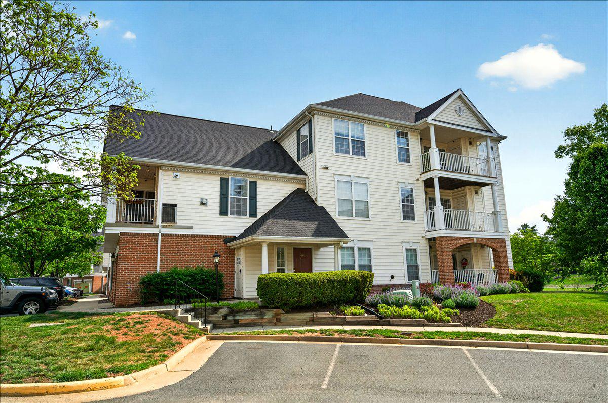 Open House 11-1 Sunday, May 10. Newer HVAC and Water Heater!! 1 Car Garage & Driveway! Set against a peaceful lakeside backdrop in the sought-after South Riding community, this inviting 2-bedroom, 1-bath condo offers a blend of privacy (no units BELOW or ABOVE), comfort, style, and everyday convenience. The lower level entry provides a welcoming foyer with a storage closet, garage access and a wide staircase leading up to the main living space, a perfect example of the home’s functional layout. On the main level you are welcomed with a soaring vaulted ceiling that creates an airy, open feel, complemented by durable LVP flooring and a cozy gas-burning fireplace that anchors the living room—perfect for quiet evenings or gathering with friends. Just beyond, the dining area flows seamlessly to a private balcony, where there’s room for a table and chairs, making it easy to enjoy morning coffee or unwind at the end of the day. The beautifully updated kitchen is thoughtfully designed with granite countertops, stainless steel appliances, recessed lighting, and a peninsula with seating, ideal for casual meals or entertaining. Down the hall you find both comfortably sized bedrooms fitted with Smart Strand Mohawk carpeting. The primary suite features two large closets and convenient access to the shared bath (also accessed from the hallway), which has a double sink vanity and tub/shower combination. Outdoor spaces include not only the balcony, but also a charming front porch with a view of the lake—an ideal spot to take in the surroundings. A one-car garage and an additional parking space add everyday ease. Beyond the home, South Riding offers an exceptional lifestyle with access to multiple outdoor pools, tennis and pickleball courts, basketball courts, a dog park, playgrounds, and miles of scenic trails. With community gathering spaces, fishing piers, and open green areas, this home offers the perfect balance of low-maintenance living, and access to vibrant amenities—all in a serene, lakeside setting.