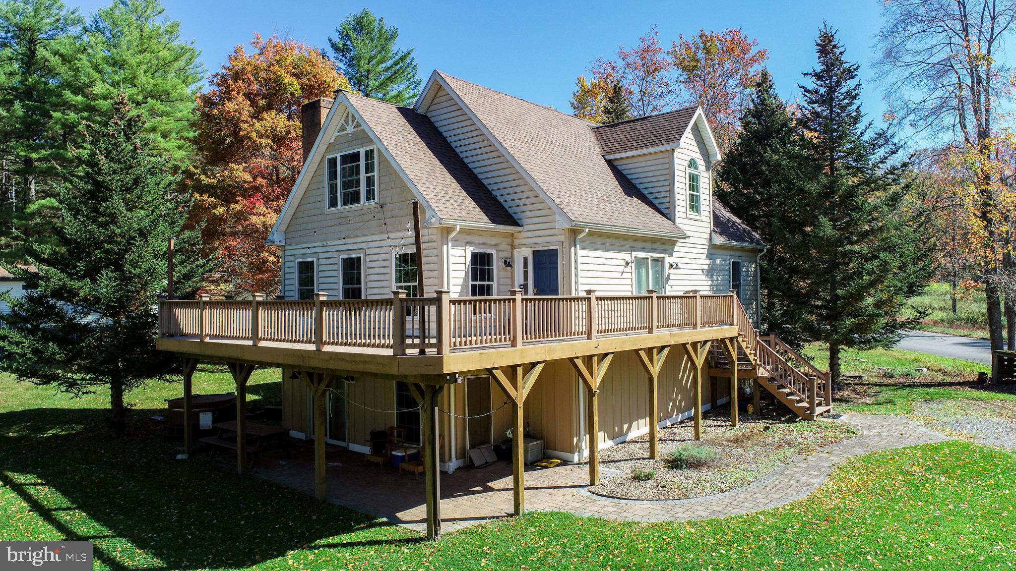 Hazelhurst community is on the Southern end of the lake.  Here you will find less commercial activity and more peace and quiet to enjoy.  This three-level chalet offers 5 bedrooms, with bedrooms on each floor, 3 baths, large living room, dining room, and 2 fireplaces to enjoy. One gas and one wood.  An over-sized family/rec room. Large walk-out deck on the main level with views of the lake or the lower level covered patio with a hot tub. Home has been well maintained and is ready to move-in and enjoy. The yard area offers a fire ring, horse shoes and plenty of space for other recreational activities.  No boat dock but maybe a swim platform.  This is a must-see lakefront opportunity with a great location. Enjoy all four seasons.