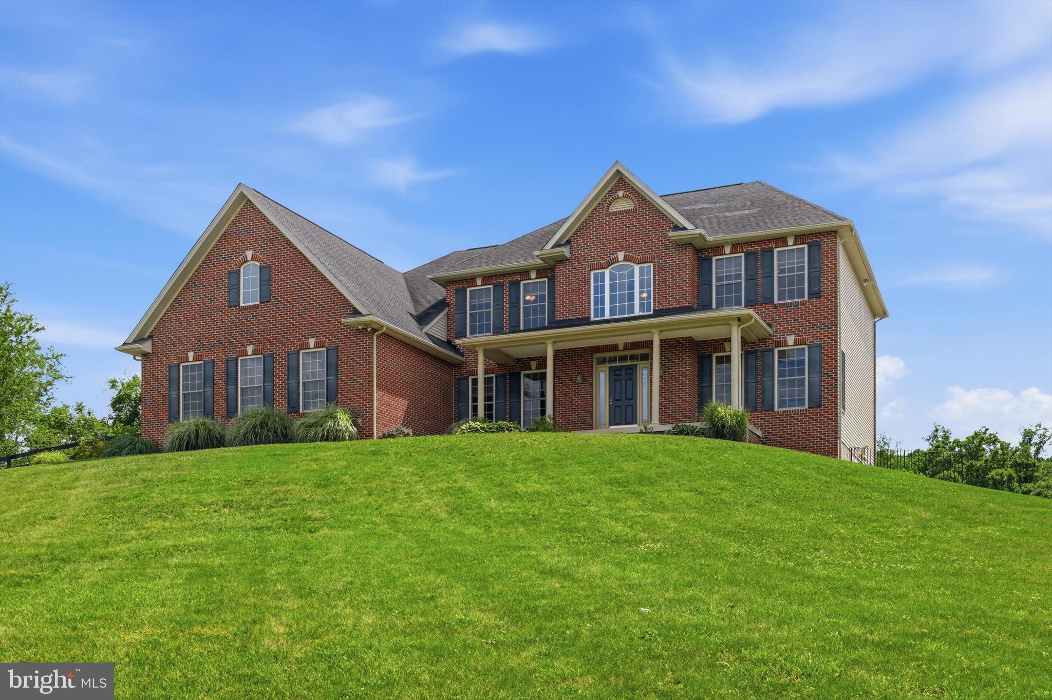 Imagine waking up every morning to panoramic views of South Mountain from your very own 3.26-acre fully fenced property. This stately colonial offers that and so much more! Custom-built in 2005 by local builder Kent Brindell, known throughout the region for quality craftsmanship and attention to detail, this exceptional 4-bedroom, 2.5-bath residence offers more than 5,100 square feet of finished living space, an oversized 3-car garage, breathtaking views from every window, and endless opportunities both inside and out. Thoughtfully prepared for its next chapter, recent improvements include fresh paint throughout, brand-new carpet, new LVP flooring in the lower level, updated lighting, a newer tankless hot water heater, a new refrigerator, and a brand-new compressor serving one of the dual-zoned HVAC systems. The heart of the home is a spacious kitchen featuring custom soft-close maple cabinetry, stainless steel appliances, ceramic tile backsplash, under-cabinet lighting, a center island, a dedicated desk workspace, a separate pantry, and an inviting breakfast area. The kitchen flows seamlessly into the family room, highlighted by a propane fireplace and an attractive shiplap accent wall.  French doors open into the adjoining sunroom with dedicated heating and air conditioning and direct access to the backyard. The main level also offers a formal dining room, private office, flexible living space, hardwood flooring, a dramatic two-story foyer, and extensive crown molding and chair rail detailing throughout. Upstairs, all four bedrooms have been freshly painted and fitted with new carpet. The spacious primary suite serves as a private retreat, complete with a large walk-in closet featuring a custom organization system and a luxurious bath offering a soaking tub, and a separate shower. Both full bathrooms feature double vanities, providing convenience and functionality for busy households. The recently finished lower level adds tremendous flexibility with new LVP flooring, recessed lighting, French doors leading to the side yard, a rough-in for a future bathroom, and an excellent balance of finished living space and unfinished storage. Built with quality and longevity in mind, the home features 2x6 construction, Tyvek house wrap, R-19 insulation, a poured concrete foundation, 400-amp electrical service plus a dedicated 100-amp generator service, security system, sediment filtration system, sump pump, radon plumbing, and double-hung windows that tilt inward for easy cleaning. Outside, the possibilities are endless. Whether you're planning for a growing household, multigenerational living, or simply desire more room to spread out, this home delivers exceptional space and versatility. The fully fenced acreage provides room for horses, chickens, gardens, recreational pursuits, or simply enjoying the privacy and open space. Additional outdoor amenities include a paver patio, fire pit, chicken coop, and asphalt driveway. Located in the desirable Boonsboro School District with no HOA, this remarkable property combines custom construction, modern updates, and a setting that is difficult to replicate. The current owners' favorite feature remains the spectacular South Mountain views enjoyed from the front porch year-round.