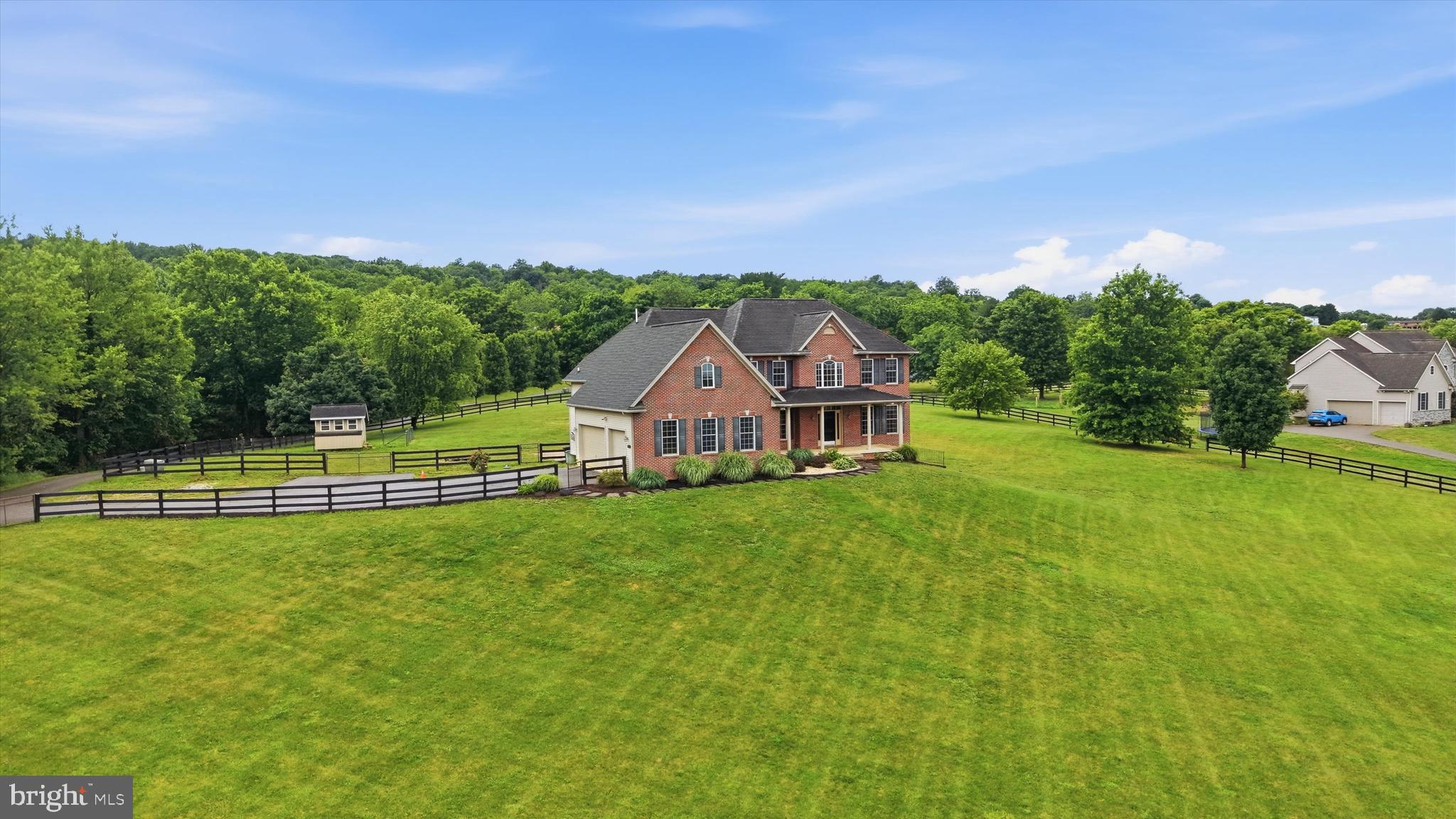 Imagine waking up every morning to panoramic views of South Mountain from your very own 3.26-acre fully fenced property. This stately colonial offers that and so much more! Custom-built in 2005 by local builder Kent Brindell, known throughout the region for quality craftsmanship and attention to detail, this exceptional 4-bedroom, 2.5-bath residence offers more than 5,100 square feet of finished living space, an oversized 3-car garage, breathtaking views from every window, and endless opportunities both inside and out. Thoughtfully prepared for its next chapter, recent improvements include fresh paint throughout, brand-new carpet, new LVP flooring in the lower level, updated lighting, a newer tankless hot water heater, a new refrigerator, and a brand-new compressor serving one of the dual-zoned HVAC systems. The heart of the home is a spacious kitchen featuring custom soft-close maple cabinetry, stainless steel appliances, ceramic tile backsplash, under-cabinet lighting, a center island, a dedicated desk workspace, a separate pantry, and an inviting breakfast area. The kitchen flows seamlessly into the family room, highlighted by a propane fireplace and an attractive shiplap accent wall.  French doors open into the adjoining sunroom with dedicated heating and air conditioning and direct access to the backyard. The main level also offers a formal dining room, private office, flexible living space, hardwood flooring, a dramatic two-story foyer, and extensive crown molding and chair rail detailing throughout. Upstairs, all four bedrooms have been freshly painted and fitted with new carpet. The spacious primary suite serves as a private retreat, complete with a large walk-in closet featuring a custom organization system and a luxurious bath offering a soaking tub, and a separate shower. Both full bathrooms feature double vanities, providing convenience and functionality for busy households. The recently finished lower level adds tremendous flexibility with new LVP flooring, recessed lighting, French doors leading to the side yard, a rough-in for a future bathroom, and an excellent balance of finished living space and unfinished storage. Built with quality and longevity in mind, the home features 2x6 construction, Tyvek house wrap, R-19 insulation, a poured concrete foundation, 400-amp electrical service plus a dedicated 100-amp generator service, security system, sediment filtration system, sump pump, radon plumbing, and double-hung windows that tilt inward for easy cleaning. Outside, the possibilities are endless. Whether you're planning for a growing household, multigenerational living, or simply desire more room to spread out, this home delivers exceptional space and versatility. The fully fenced acreage provides room for horses, chickens, gardens, recreational pursuits, or simply enjoying the privacy and open space. Additional outdoor amenities include a paver patio, fire pit, chicken coop, and asphalt driveway. Located in the desirable Boonsboro School District with no HOA, this remarkable property combines custom construction, modern updates, and a setting that is difficult to replicate. The current owners' favorite feature remains the spectacular South Mountain views enjoyed from the front porch year-round.