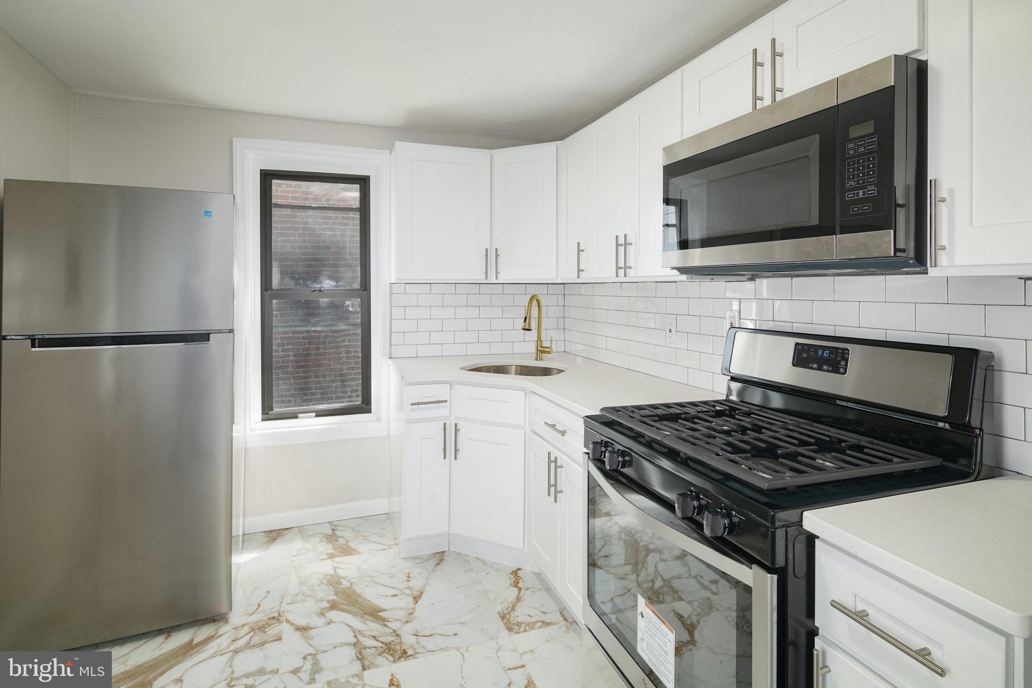Welcome to this stunning, fully renovated unit located in the heart of POINT BREEZE! This one-bedroom, one-bathroom unit has been beautifully updated with hardwood floors, elegant large marble tiles, recessed lighting, and Ductless Mini-Split Wall Units for efficient cooling. The spacious eat-in kitchen boasts ample cabinet space, stainless steel appliances, including a built-in microwave, and upgraded countertops. The oversized bedroom offers generous closet space for all your storage needs, complemented by a modern light fixture. The bathroom is a work of art, featuring textured marble-style tiles, a contemporary white vanity with storage, and a mirrored vanity above the sink for your toiletries. The large tub shower is equipped with modern tiles and fixtures. Located in the sought-after Point Breeze neighborhood, this unit is a walker's paradise with a Walk Score of 94. All your daily necessities are just a short stroll away, including groceries, schools, dining options, cafes, bars, and shopping. Nearby parks like Girard Park, Smith Playground, and Wilson Park offer outdoor recreational opportunities. Don't wait too long; this unit is sure to be in high demand. Schedule your showing today before it's gone!