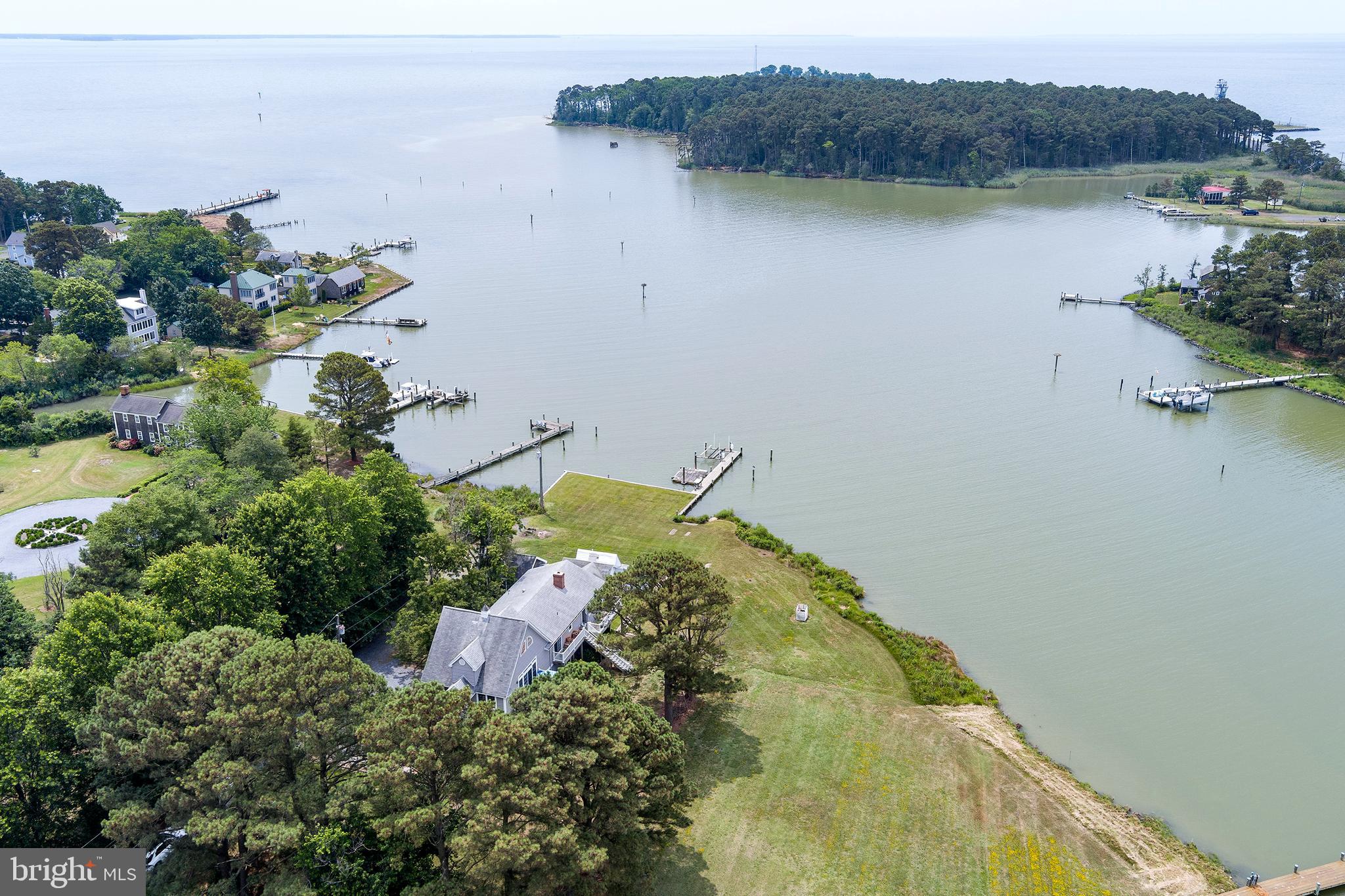 Tucked away in the charming Fairbank community on Tilghman Island, this delightful waterfront home captures the very best of Eastern Shore living. Overlooking the serene waters of Blackwalnut Cove with approximately 3’ MLW, the property blends classic cottage character with thoughtful modern enhancements. The original portion of the home reflects its roots as a cozy summer cottage, complete with a charming screened porch perfect for enjoying warm breezes and waterfront views. A connected wing was elevated 10 feet and now features a spacious two-car garage on the main level, offering abundant storage for boats, kayaks, and gear. The rear wing provides exceptional versatility with a private studio apartment—currently a licensed B&B with its own entrance—ideal for guests, rental income, or multigenerational living. Inside the main home, a wood-burning fireplace invites you to curl up on cool days and evenings, while the screened porch becomes the heart of the home during warmer months. With 4 bedrooms and 3 baths, this property offers comfort, flexibility, and the relaxed coastal lifestyle that defines the Eastern Shore.  Appointment-only showings.  Do not enter the property without an appointment.