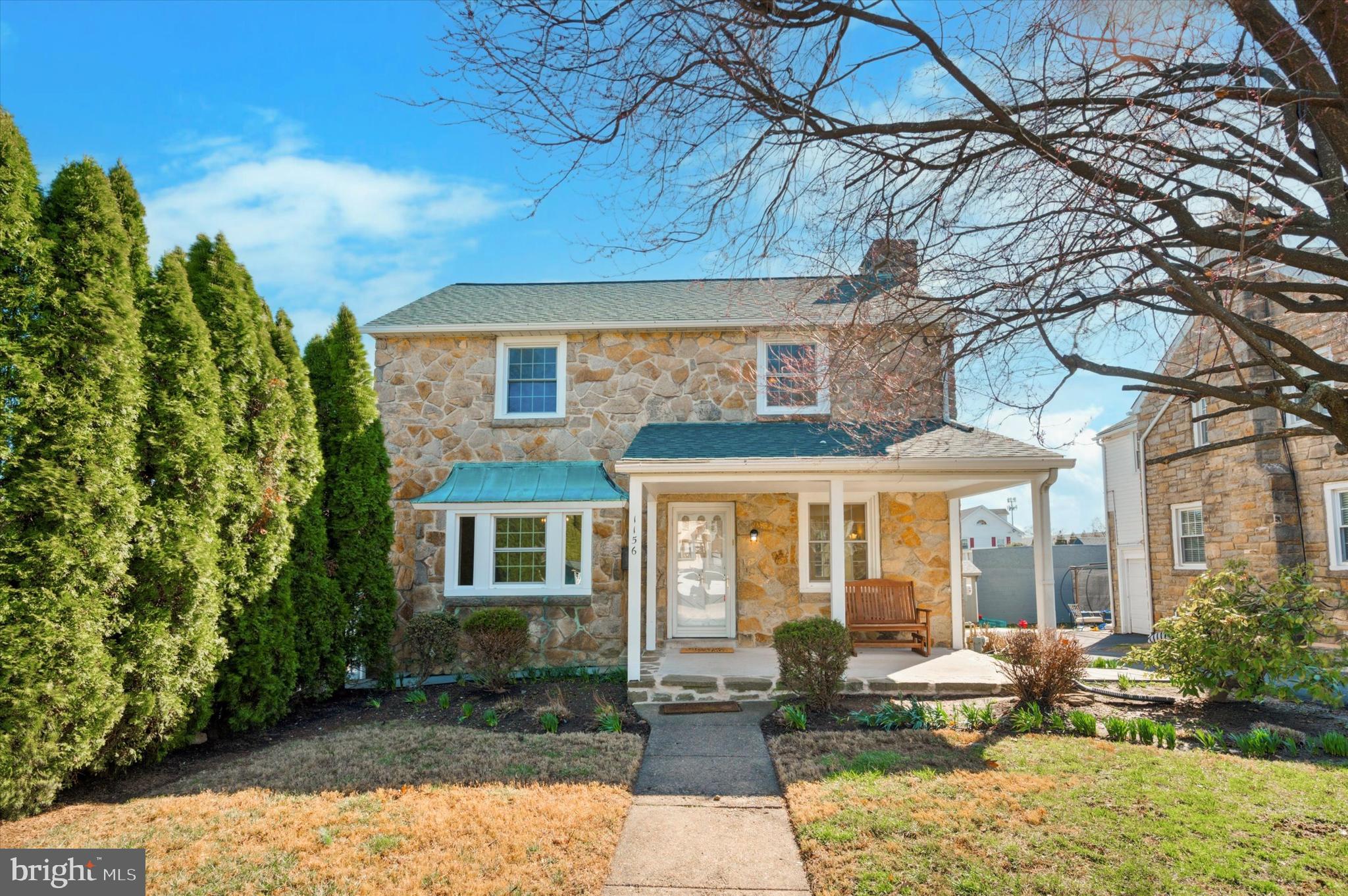 Your new rental home in Havertown just hit the market! This stone Colonial home has charming curb appeal and is equally inviting once you step inside! At just over 2200 SF of finished space, it will provide plentiful room for its next occupant, with 4 bedrooms, 3.5 bathrooms, partially finished basement, and attic space. It also includes an additional lot for an oversized yard space to enjoy - a rare find in Havertown! The home's main level includes the bright living room with wood-burning fireplace centerpiece and built-in shelving, formal dining room with bay window, and updated kitchen with ample white shaker cabinetry, granite counters, tiled backsplash, and recessed lighting. Here, you'll also find the mudroom with bench and storage, pocket door to the powder room, and door leading to the large deck with yard access. Head upstairs to the primary bedroom, including remodeled ensuite bathroom with stall shower. Another 3 bedrooms and hall bath complete this level - all bedrooms include ceiling fans with lighting. There's also the partially finished walkout basement with full bathroom, which provides versatile usable space - make it an office area, 5th bedroom, or whatever suits your needs! The unfinished space includes utility area and laundry. A floored attic with pull-down stair provides additional storage space. 1-car attached garage and shared driveway. Additional features include radiant heating, 2 flagstone patios, storage shed, new concrete pad covered front porch, plentiful closet space,  new roof 2023, and a tree-lined lot for privacy. This home has been lovingly cared for and received many upgrades that its next occupant is sure to enjoy - most recently it was freshly painted with hardwood floors refinished. This home really shines inside and out! Schedule some time to see it and make it your next rental home!