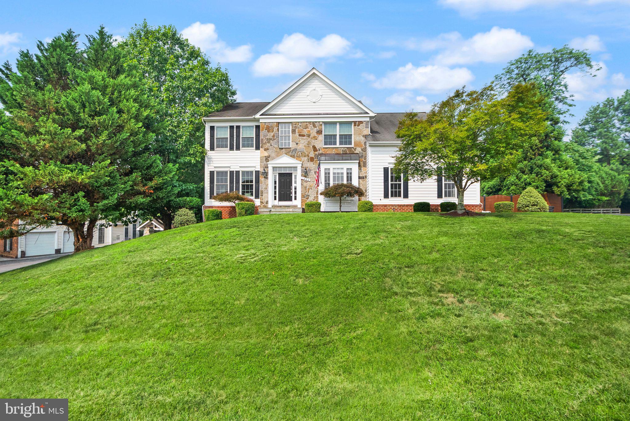 Set in scenic Lovettsville, this well-kept home offers a comfortable layout, peaceful views, and a great mix of everyday function with recent updates. Open lawn and a classic exterior with attached garage create a welcoming first impression.

Inside, a two-story foyer leads into a practical main-level layout with hardwood floors, defined living and dining rooms, and a relaxed family room with a fireplace. The kitchen features wood cabinetry (recently refreshed with new paint), a center island, cooktop, wall oven, and breakfast area, with dishwasher, stove/oven, microwave, and refrigerator all updated in 2021. The adjacent sunroom offers great natural light and yard views.

Upstairs, updated flooring (2021) gives the bedroom level a fresh feel. The spacious primary suite includes a private bath with soaking tub, separate shower, and dual vanity. The finished walk-out lower level adds a full bedroom, a large rec room, and excellent storage.

The backyard — a seller favorite — offers open lawn, mature landscaping, a stone patio, and a fully fenced yard, perfect for relaxing or entertaining.

Additional updates: windows (2021), both A/C units (2024), furnace (2024), and washer/dryer (2025).

A spacious layout, scenic setting, and thoughtful updates make this Lovettsville home a great find in Loudoun County.
