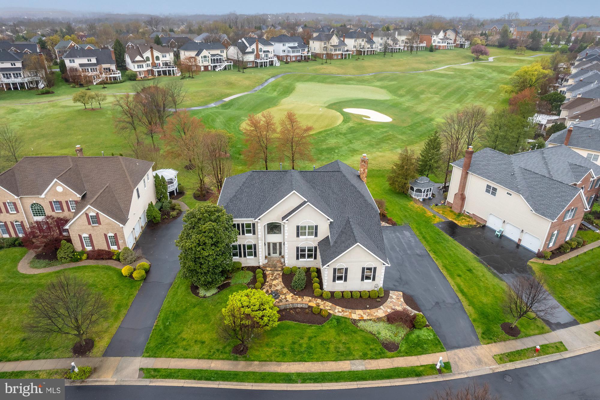 "Living the Dream" at Belmont Country Club!  This Estate Series Home Backs the 11th Green and Enjoys Great Views!  Inside You'll Find Modern Updates Throughout!  The Chef's Kitchen Opens to the Family Room and Solarium & Custom Built Covered Porch!  The Two Story Family Room features a Stone Fireplace and Box Beamed Ceiling!  It also includes a Designer Chandelier and Remote Controlled Blinds!  The Primary Bedroom features a Coffered Ceiling with Night Lighting, Two Walk-In Closets and a Fully Updated Luxury Bath!  The Lower Level is Great for all and includes a Custom Built Bar with Glass Enclosed Wine Cellar, Game Room, Family Room w/ Fireplace, Hobby Room and Den!  The Lower Level Full Bath is Equipped with a Sauna too!  Outside, You'll Love the Covered Porch and Flagstone Patio!  New HVAC (Both Systems)!  Great Location!  Just a Few Block from the Shops at Belmont Chase, The Rec Center or The Country Club!