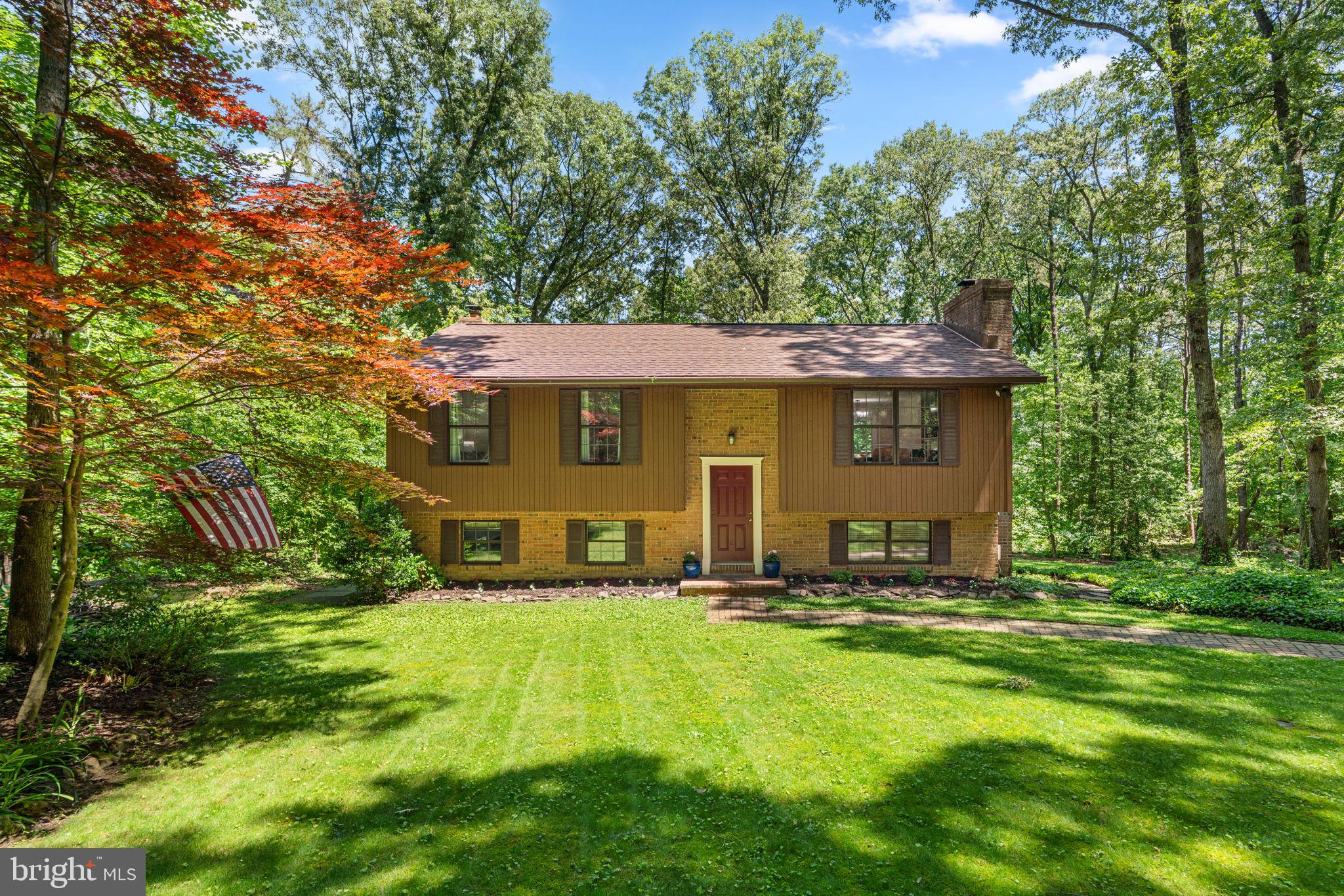 Located on a serene, partially wooded 2-acre lot in the highly desirable Severna Park school district, this beautifully updated split foyer home offers the perfect blend of privacy, comfort, and convenience. Surrounded by lush landscaping and peaceful wooded views, the property feels like a private retreat while remaining just minutes from shopping, restaurants, parks, hospitals, and commuter routes to Annapolis, Baltimore, and Washington, D.C.
Built in 1982 with charming wood siding, this 3-bedroom, 2-bath home is designed for both everyday living and entertaining. Inside, hardwood floors flow throughout the main living areas, while the renovated kitchen features granite countertops, a stone backsplash, under-cabinet lighting, updated sink and fixtures, and tile flooring. Both bathrooms have been thoughtfully updated with stylish finishes, including a heated tile floor in the upstairs bath.
The fully finished walkout lower level offers exceptional additional living space, complete with a spacious tiled family room, wood stove, new drop ceiling, and updated lighting — the perfect setting for cozy evenings or gatherings with friends and family. A traditional fireplace upstairs adds even more warmth and character to the home.
Major improvements provide peace of mind, including a newer roof with transferable warranty, updated HVAC system and heat pump, newer hot water heater, well pump, and PEX plumbing throughout. Outdoor living shines with a composite deck featuring a built-in grilling station and cabinetry, stone patio, multiple firepit areas, basketball court, and expansive yard with endless possibilities for recreation, gardening, or simply enjoying nature. A shed and wood storage building provide added storage and functionality.
Enjoy close proximity to Kinder Farm Park, Downs Park, and the B&A Trail. Offering the tranquility of country-style living with modern updates and exceptional outdoor space, this  special property is truly a place to call home. Schedule your private tour today!