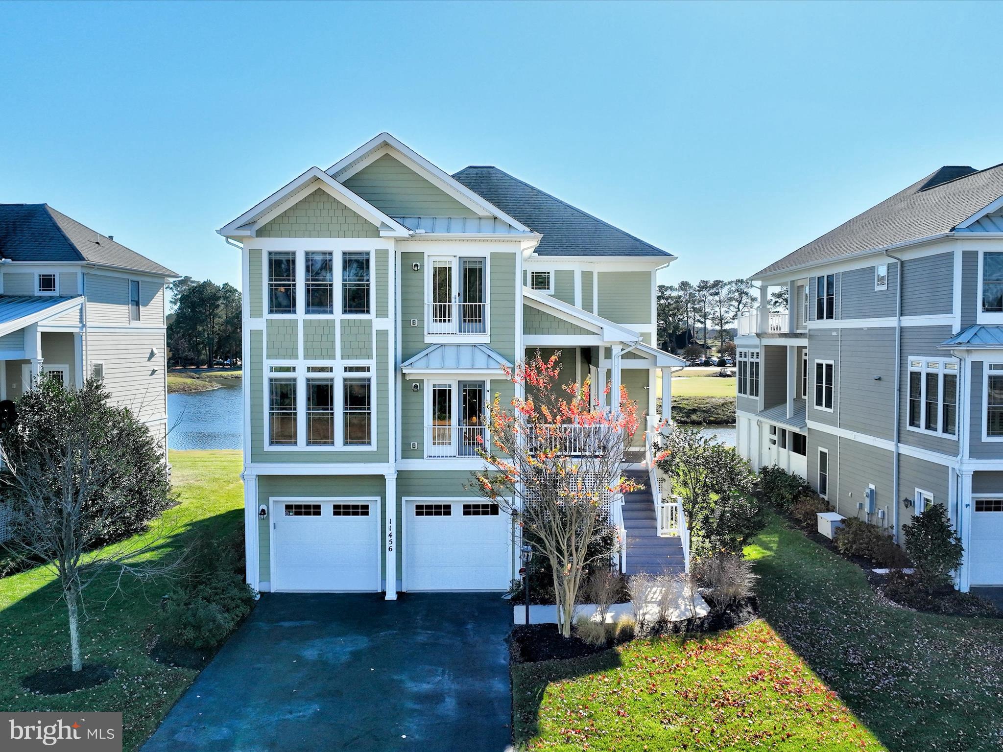Welcome to 11456 Maid At Arms Lane, a spectacular residence nestled between Glen Riddle’s premier golf course and the serene Gum Point Creek, which leads directly to the bay. This exquisite three-level home offers captivating water, golf, and nature views, with elegant architectural details and expansive living spaces that celebrate coastal charm. The stately exterior, designed in a coastal-inspired style, invites you to ascend to the welcoming main level. Inside, a light-filled open-concept design makes entertaining effortless, with fluid transitions between inviting living areas. The spacious living room, crowned by a soaring two-story ceiling, is anchored by a two-sided gas fireplace framed by custom-built bookcases. The adjacent sunroom offers panoramic vistas of water, golf greens, and lush landscapes—a perfect backdrop for quiet reflection or lively gatherings. The gourmet kitchen is a chef’s dream, showcasing granite countertops, 42” custom cabinetry, and high-end stainless-steel appliances, including a double wall oven. A peninsula breakfast bar opens to a sun-drenched nook with a cozy sitting area, ideal for savoring morning coffee with bay views. A convenient pass-through connects to the formal dining room, ideal for grand gatherings. The main level also hosts a luxurious primary suite, complete with an expansive walk-in closet and a spa-like ensuite featuring a soaking tub, dual vanities, and a generous stall shower.  Ascend to the upper level to discover a tranquil loft, perfect for escaping with a good book, along with a second primary suite. This private sanctuary mirrors the main level’s suite and includes balcony access to a sun deck that overlooks the golf course, with sweeping views that stretch for miles. Two additional bedrooms with unique designs share a full bath, and a dedicated laundry room completes this floor. The thoughtfully designed spaces continue on the lower level, where an in-law suite offers an ideal retreat for extended family or guests. This level features a cozy family room with a walkout to a screened porch—a perfect spot for enjoying a crab feast with loved ones against the scenic golf course backdrop. A convenient kitchenette, a fifth bedroom, a full bath, and a second laundry room make this level fully self-sufficient, while an adjacent mudroom with ample storage connects seamlessly to the attached two-car garage. Each floor also includes a spacious storage closet, stacked to allow for future elevator installation if desired. Additionally, the current owners have a boat slip available for purchase, adding to the home's convenience and appeal.

This celebrated community is steeped in historical significance, once known for its prestigious equestrian farm. Many champions and winners were trained here including the legendary race horse Man O’ War. Today, GlenRiddle boasts two championship golf courses, a 96-slip marina, and a state-of-the-art owner’s community center with an outdoor pool, fitness center, sports lounge, tennis courts, and more, offering an exceptional blend of luxury, leisure, and lifestyle. Make 11456 Maid At Arms Lane your forever home—a place where coastal beauty, modern comforts, and timeless history converge.