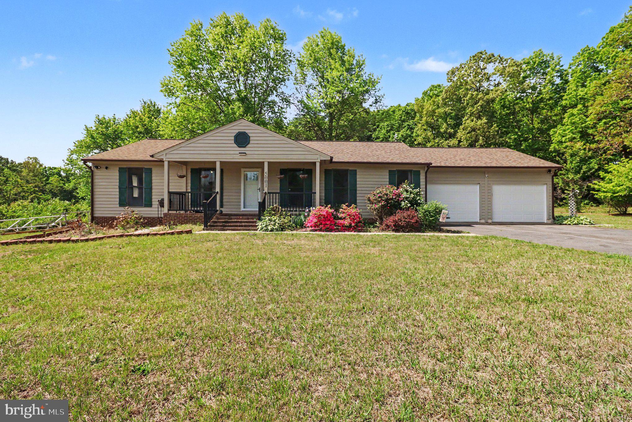 Welcome home to a spacious 1.5-acre lot offering the perfect blend of open field space and mature trees, just a few hundred yards from Lake Anna! This home offers over 3,000 square feet of living space and features a welcoming front porch with vinyl railings, attractive wood siding, and a recently replaced roof on the home and both sheds in 2024.

The oversized two-car garage is a standout feature — ideal for a mechanic, car enthusiast, hobbyist, or anyone needing extra workspace and storage, complete with extensive built-in cabinetry.

Inside, you’ll find gleaming hardwood floors and a beautifully renovated kitchen featuring shaker cabinetry with crown molding, quartz countertops, an attractive backsplash, stainless steel appliances, and tile flooring. All three bathrooms include newer vanities, adding to the home’s updated feel.

The finished basement offers additional flexible living space with LVP flooring, plus a supplemental mini-split system equipped with the ability to connect directly to solar panels, along with a solar panel transfer switch.