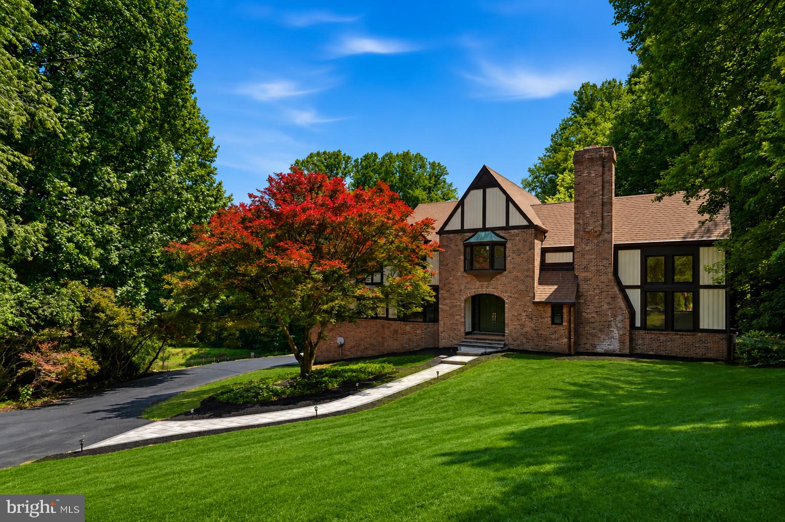 Where timeless elegance meets modern luxury, this extraordinary Howard County Tudor is the home dreams are made of. Meticulously renovated from top to bottom with impeccable attention to detail, this exceptional residence offers refined living, grand entertaining spaces, and resort-style outdoor amenities.

A breathtaking two-story foyer welcomes you with rich exposed brick accents, soaring ceilings, and dual coat closets, setting the stage for the sophistication found throughout. The dramatic great room is the centerpiece of the home, showcasing 18-foot ceilings, expansive windows that flood the space with natural light, and a stunning wood-burning fireplace that creates an atmosphere of warmth and grandeur.

Designed for both elegant entertaining and everyday living, the formal dining room provides the perfect setting for memorable gatherings, while the distinguished library, complete with custom built-in cabinetry, offers an ideal executive home office or private reading retreat.

The spectacular gourmet kitchen is a chef's masterpiece, featuring premium finishes, abundant cabinetry, and an open-concept design that flows effortlessly into the inviting family room, where a second wood-burning fireplace creates the perfect backdrop for intimate evenings with family and friends.

The upper level is a luxurious sanctuary, featuring brand-new plush carpeting throughout and four generously proportioned bedrooms. The lavish primary suite serves as a private retreat, complete with a spa-inspired bath boasting an oversized walk-in shower, dual vanities, designer finishes, and a spacious walk-in closet designed to accommodate every wardrobe.

The fully finished lower level elevates the home's entertainment offerings with luxury vinyl plank flooring, a stylish wet bar complete with a wine refrigerator, a temperature-controlled wine cellar, a potential fifth bedroom, generous storage, and an included pool table—creating the ultimate destination for game nights, celebrations, and unforgettable gatherings.

Step outside to your own private oasis. An expansive deck overlooks a beautifully landscaped backyard framed by mature trees, offering exceptional privacy. The stunning in-ground pool and spa transform the outdoor space into a five-star retreat, perfect for relaxing summer afternoons, elegant al fresco dining, or entertaining on a grand scale.

Perfectly blending classic Tudor architecture with sophisticated contemporary finishes, this remarkable residence offers an unparalleled lifestyle in one of Howard County's most coveted communities. Every space has been thoughtfully curated to deliver comfort, elegance, and luxury at every turn.