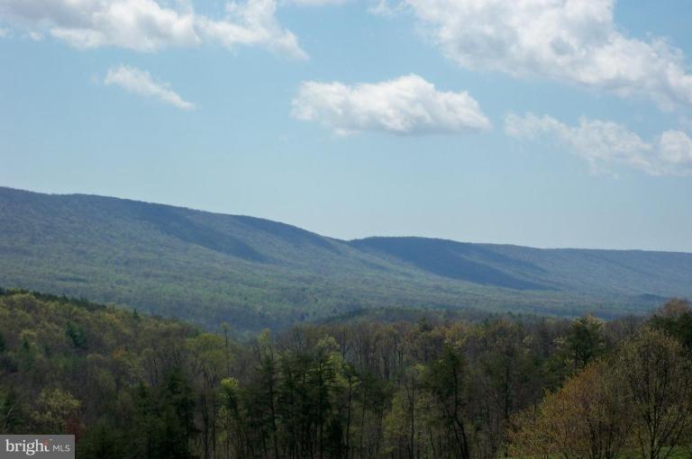 Spectacular long-range views of Sleepy Creek Mtn. This 2 acre lot on a cul-de-sac is in one of Morgan County's finest communities. Hillcrest offers underground utilities, reasonable covenants to protect your investment & handsome homes as neighbors. Perced for a 4 BR home. Seller has approved house plans for the lot which are uploaded in MLS docs. Convenient location between BS and Martinsburg.
