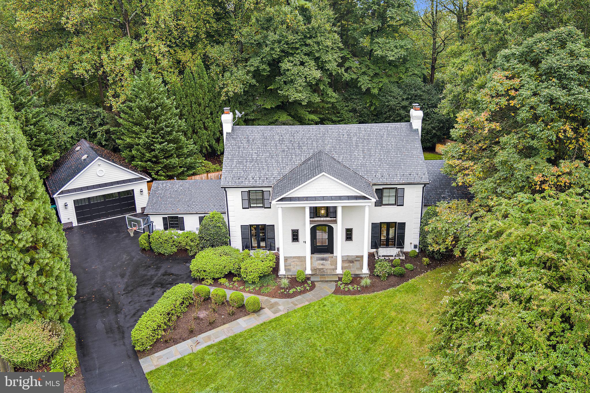 Welcome to 1 Kittery Court, a peaceful haven with a majestic street presence nestled on a serene cul-de-sac and located just off the Bradley Boulevard corridor.  This refreshed Greek revival home is set on a private and beautifully landscaped .50 acre lot and offers a peaceful retreat.  The painted brick, black windows and shutters and strong columns are a visual reminder that this is a strong home that commands respect while offering you a warm hand to step inside and feel the comforts of home.  Tradition speaks throughout the main floor of this residence.  The main level features gorgeous hand scraped hardwood floors with a soft warm honey undertone that simply welcomes all who enter.  This home is designed for both comfort and convenience.   Main level layout has an easy flow and is traditional in its styling.  There is a formal living room with corner fireplace, dining room, kitchen with marble countertops, stainless steel appliances, wine fridge, 6 burner gas range, and beautiful island, outstanding family room with wood burning fireplace, office and 2 half baths, and an updated mudroom with built in and cubbies for organization.  The true show stopping feature of this property is the full rear side of the house with sweeping multiple sets of french doors walking out from every room to the gorgeous, private back yard featuring pool, oversized stone pool deck, waterfall, koi pond and beautiful yard, all fully fenced.  Don't miss the privately cordoned off fence area to be used for pets or a separate vegetable garden and easy entrance to the detached garage.  The views are breathtaking!  The main bedroom level has 4 bedrooms and 3 full baths.  The primary suite is comfortable with a large walk-in closet and a primary en-suite bath with soaking tub and walk in shower.  The finished 4th level has a full bedroom, full bath and a bonus room for many uses such as gaming room, office or quiet space for relaxation.  The fully finished and renovated walk-up lower level complete with bedroom, full bath and extensive recreational space including wet bar with refrigerator, dishwasher and built-in cabinetry and wood burning fireplace offers tremendous entertaining space.  The oversized laundry area is complete with closets, cabinetry and two sets of washers and dryers for the active households.  The elevator services 3 floors in the home for ease and convenience.  The detached garage is currently set as an added play area complete with rock climbing wall and tremendous storage area above the finished space accessed by a built in staircase.  Full home generator for stormy weather.  If privacy is what you seek in a fabulous location, this is the property that will certainly pique your interest.