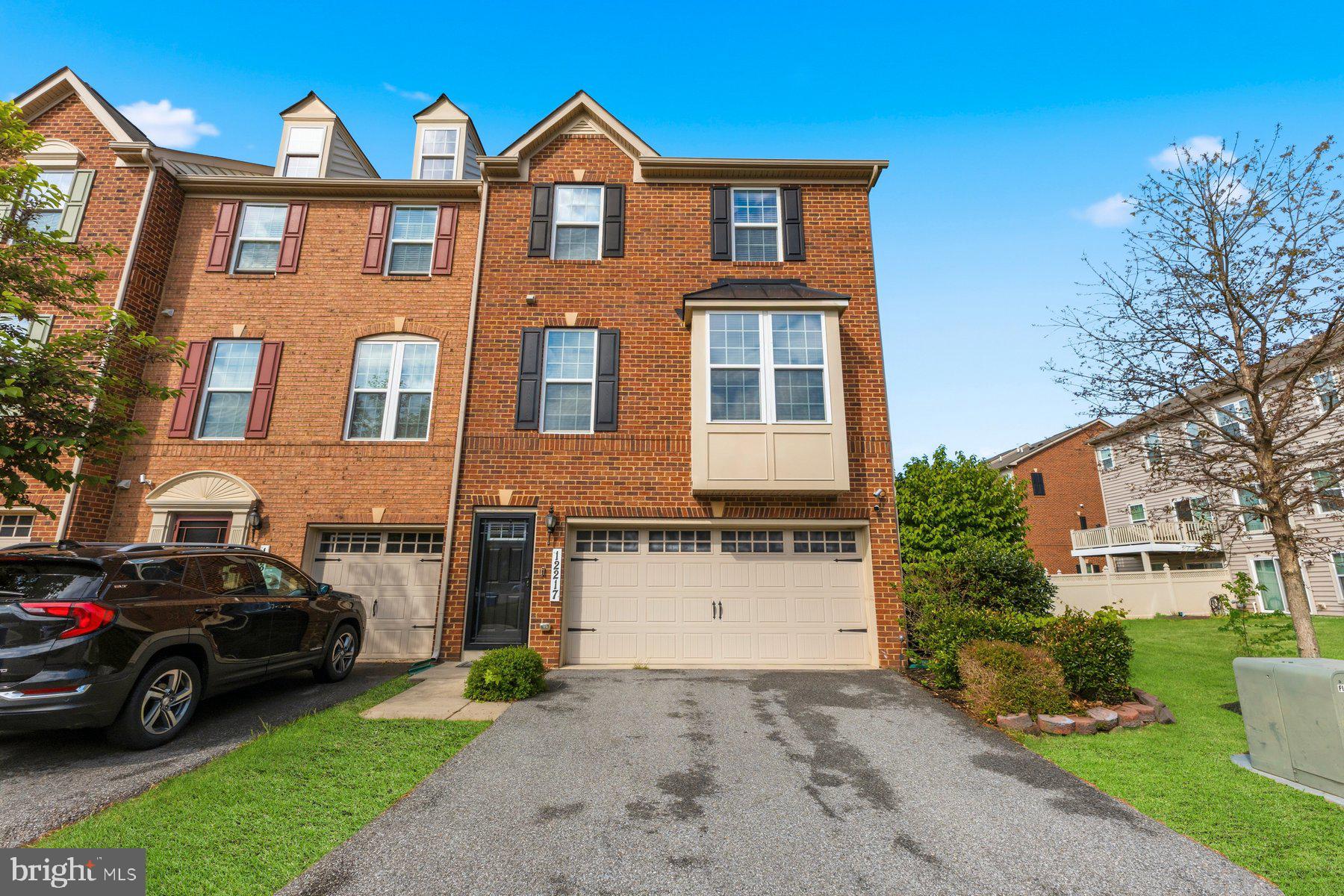 Welcome to Adams Crossing, where space, style, and thoughtful design come together in this stunning end-unit brick townhome offering over 2,400 square feet across three fully finished levels, a two-car garage, and 3 bedrooms, 3.5 baths. From the moment you step inside, the lower level sets the tone,  a spacious recreation room with built-in speakers, a full bath, and direct garage access make it the perfect foundation for entertaining, a private retreat, home office, or fitness space. 

The main living level is where everyday comfort meets effortless hosting. Upgraded luxury plank flooring flows throughout, anchoring an expansive family room and a beautifully appointed gourmet kitchen complete with granite countertops, stainless steel appliances, upgraded cabinetry, generous bonus cabinet storage, and a separate dining area. Step outside to your private deck, ideal for morning coffee or evening unwinding. Upstairs, the owner’s suite is a true sanctuary, featuring walk-in closet and a spa-inspired bath with a soaking tub and separate shower. Two additional bedrooms and a full hall bath offer the flexibility for family, guests, or a dedicated work-from-home space. End-unit townhomes of this size, condition, and presence are rarely available in this community. This is your opportunity to secure space, style, and convenience all in one exceptional home.