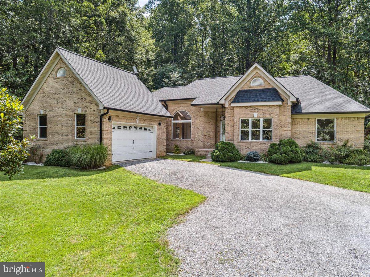 Privacy Meets Convenience on This Custom-Built 3-Acre Retreat – No HOA!

Nestled on a serene and secluded 3-acre lot, this one-of-a-kind all-brick rambler masterfully blends timeless elegance with nature’s tranquility—offering the perfect balance of peaceful seclusion and community connection. A rare find in today’s market, this home is a haven for those seeking both escape and engagement—all without the restrictions of an HOA.

From the moment you arrive, you’ll notice the custom architectural brick detailing and low-maintenance exterior that set the tone for the thoughtful design found throughout. Inside, soaring ceilings—ranging from 10 to 14 feet—flood the home with natural light, creating an airy, expansive atmosphere.

Highlights include:

• A stunning living room with cathedral ceiling

• Tray ceiling in the luxurious owner’s suite

• Vaulted hexagon ceiling in the sunlit breakfast area

• Raised ceilings in common areas and 9-ft ceilings in secondary bedrooms and bath

The heart of the home boasts a bright, open-concept kitchen complete with new stainless-steel appliances, abundant cabinetry, walk-in pantry, and a spacious eat-in breakfast area—perfect for everyday living or entertaining. Adjoining this space is a warm and welcoming family room that invites relaxation and connection.

Retreat to the owner’s suite, a private oasis featuring a spa-inspired bathroom with cathedral ceiling, separate walk-in shower, dual vanities, large walk-in closet, and private water closet. Additional bedrooms offer generous space, natural light, and distinctive architectural touches like a 3-row window bump-out with marble shelf.

Working from home? A spacious office with glass French doors provides both functionality and privacy.

Step outside to your personal backyard retreat, framed by mature landscaping, including a Magnolia tree, crepe myrtles, decorative marble-chip flower beds, and a lush Zoysia lawn. A vinyl privacy fence on the sides and chain-link at the back ensures both security and scenic views—plus, a small stream runs along the north side of the property for a natural touch of serenity.

Additional Features Include:

• No HOA

• New roof with transferable warranty (2023)

• Refinished hardwood floors, new carpeting throughout, and luxury vinyl tile in kitchen (2025)

• Fresh paint throughout (2025)

• Three storage sheds + 20-ft steel storage container

• Extensive LED lighting with dimmers throughout

• Lighting in all closets, kitchen counters, and showers

• Eight ceiling fans, including a remote-controlled fan in the living room

• Low-E/Argon gas-filled windows

• Multi-stage heat pump with heater package, UV germicidal light, and humidity control

• Wi-Fi thermostat with full reporting

• Pellet stove for added warmth

• 400-amp electrical service

• Verizon 5G UW high-speed internet

With its thoughtful design, modern updates, and unmatched setting, this home is a true sanctuary. Don’t miss your chance to experience a serene lifestyle in this unique and exceptional property—with no HOA to limit your freedom!

Be sure to check out the video walk through link for a better look! 
Showing by appointment only. No sign in the yard. Please do not drive back to the home without an appointment. Property has cameras for security.